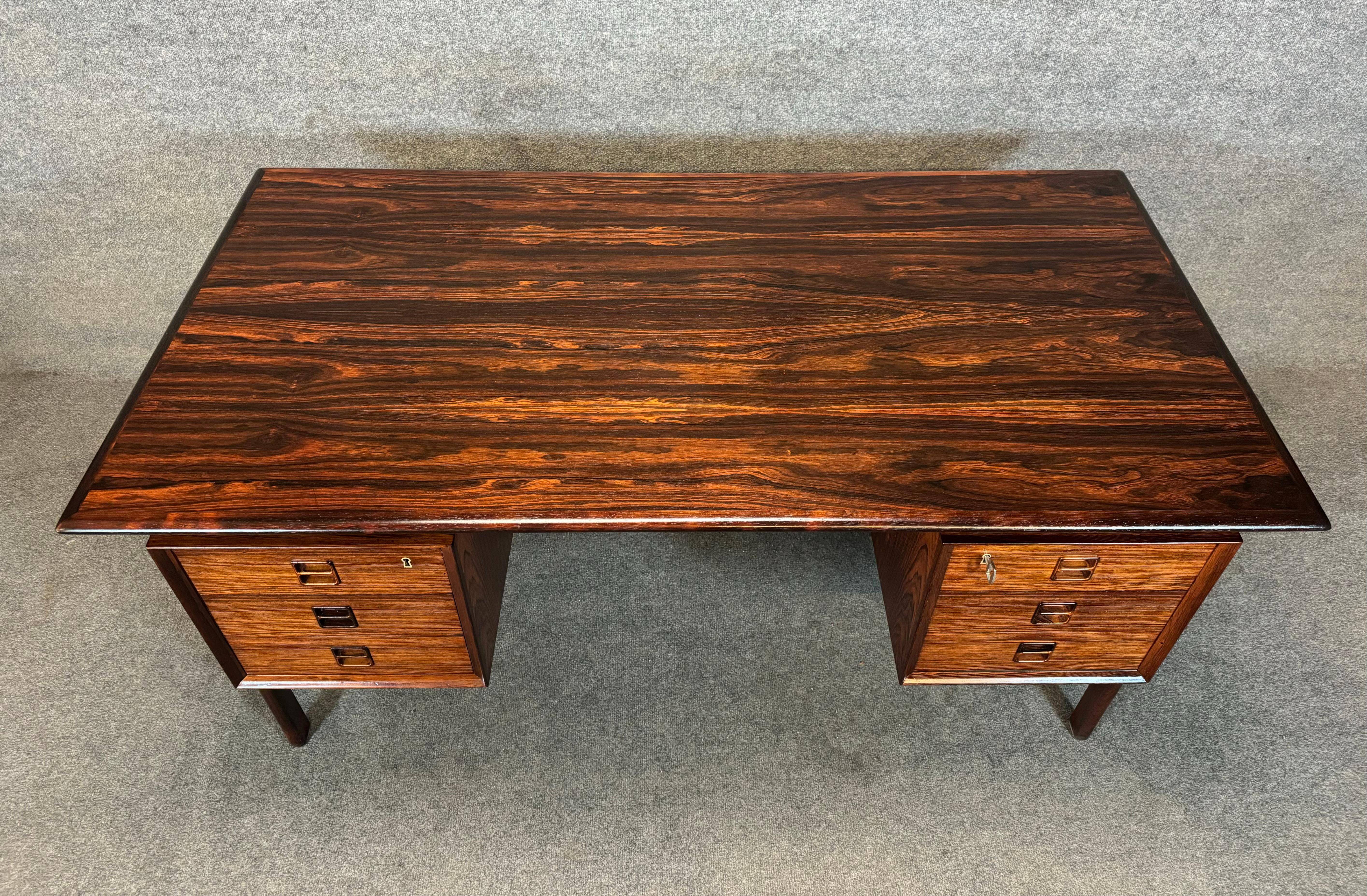 Here is a beautiful scandinavian modern rosewood desk by Gunnar Falsig Mobelfabrik, Denmark, 1960's.
This exquisite desk, recently imported from Denmark to California before its restoration, features vibrant wood grain details, a sculpted frame-legs