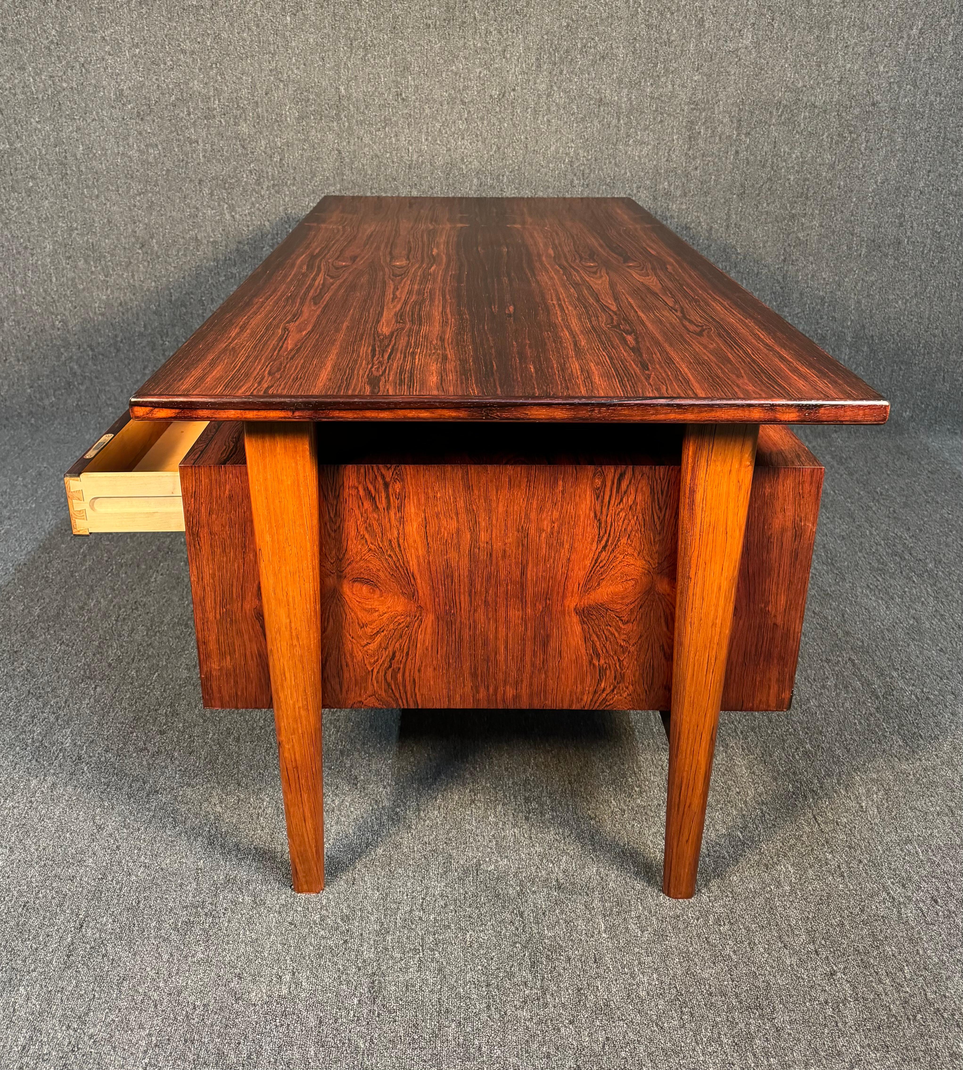 Here is a sought after Scandinavian Modern executive floating desk Model FM60 in rosewood designed by Kai Kristiansen and manufactured by Feldballe's Møbelfabrik in Denmark in the 1960's. This desk, recently imported from Europe to California before