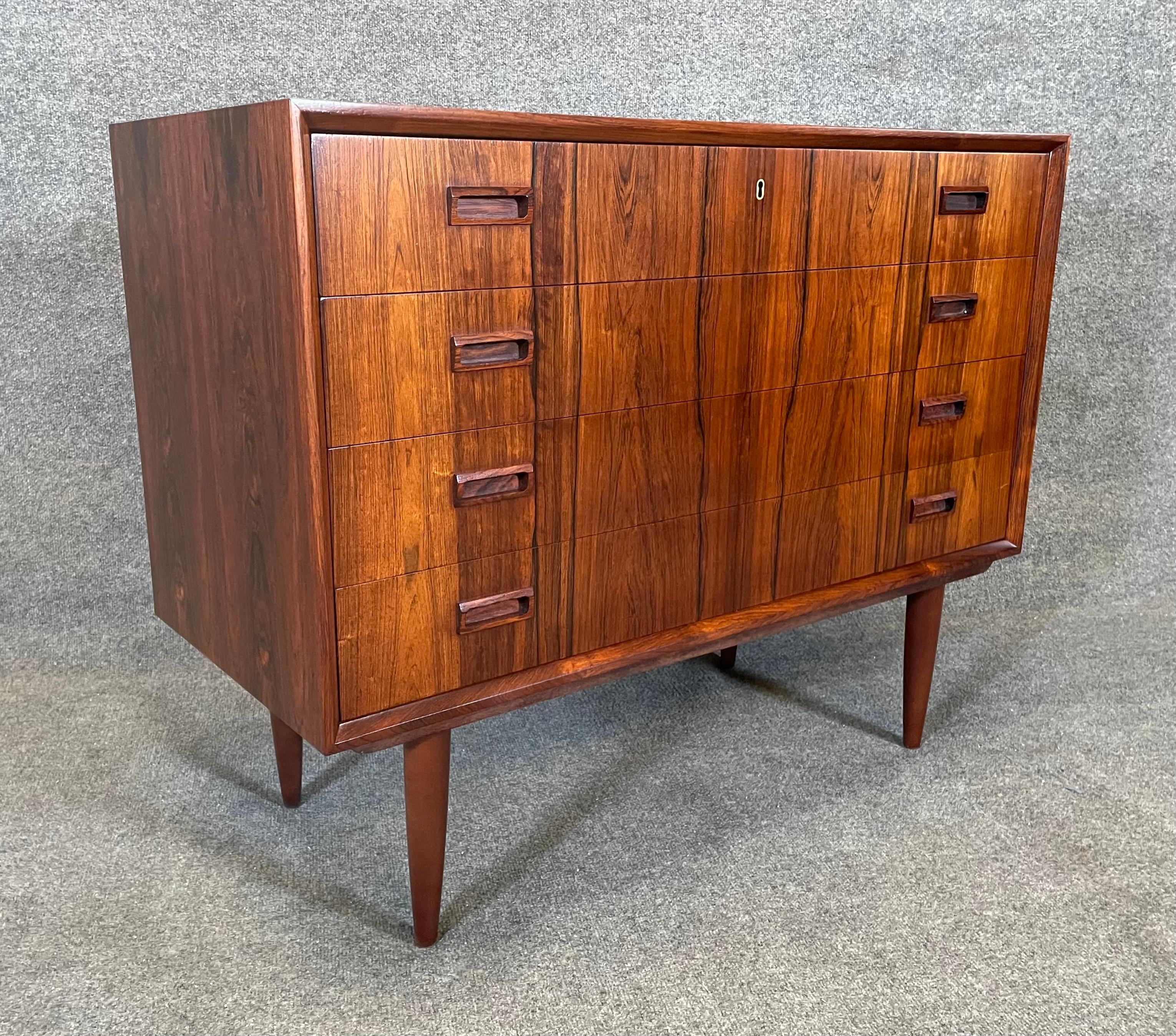 Here is a beautiful scandinavian modern chest of drawers in rosewood manufactured in Denmark in the 1960's.
This lovey case piece, recently imported from Europe to California before its refinishing, features a vibrant wood grain, a set of four dove