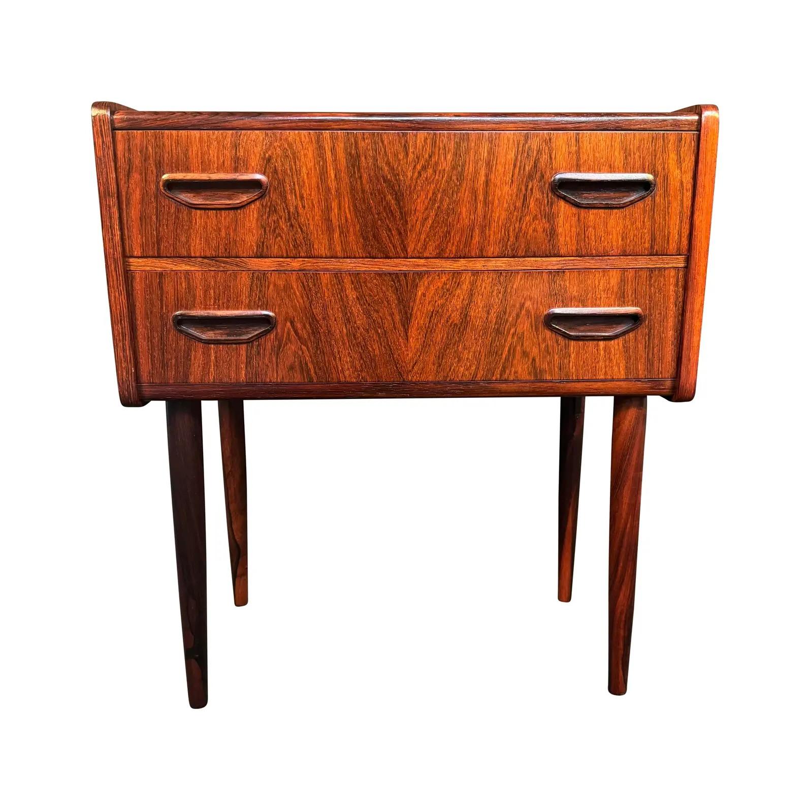 Here is a beautiful scandinavian modern rosewood entry chest in rosewood manufactured in Denmark in the 1960's.
This lovely case piece, recently imported from Europe top California before its refinishing, features a vibrant wood grain, two dove tail