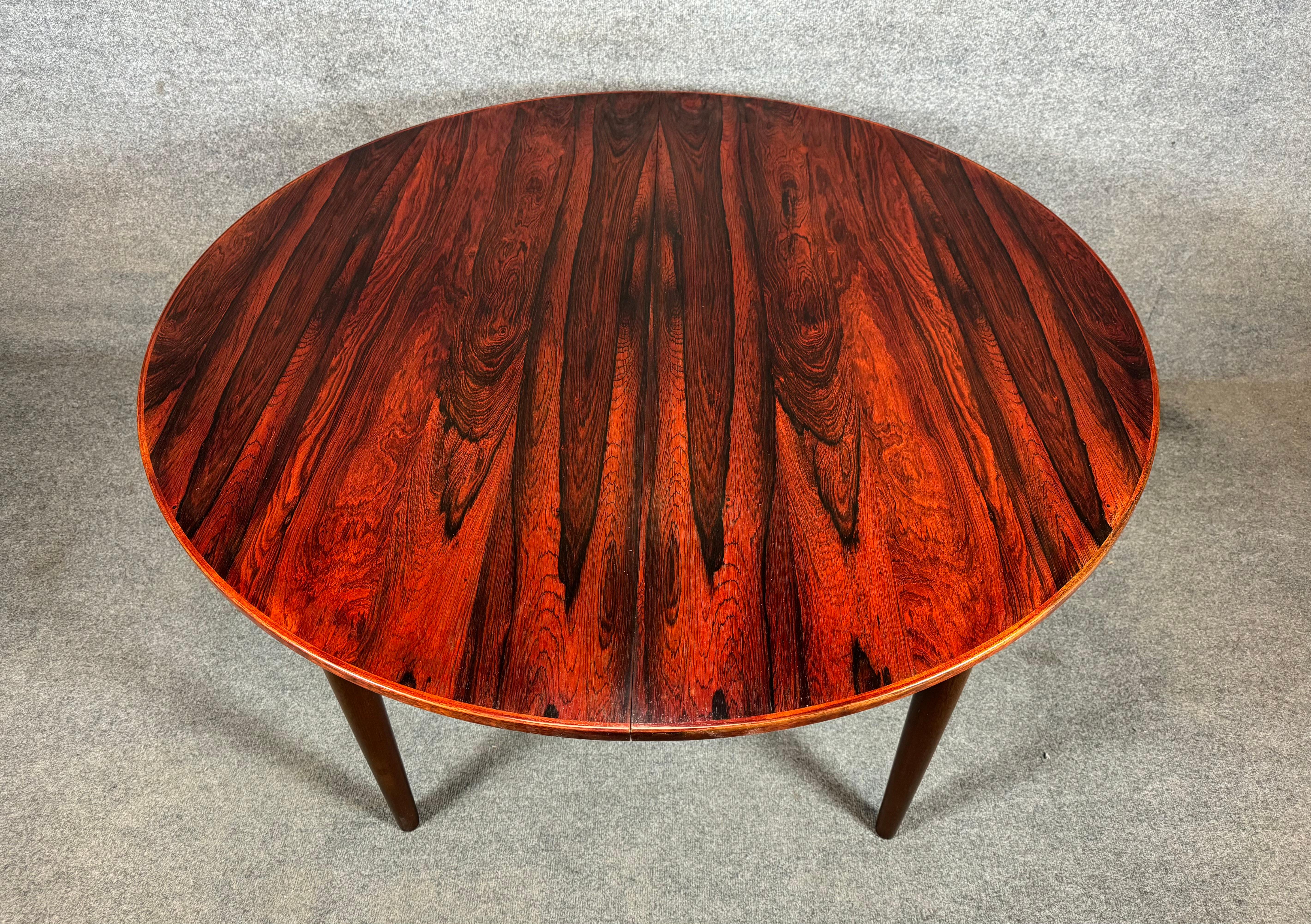 Here is a beautiful scandinavian modern dining table in rosewood manufactured in Denmark in the 1960's .
This lovely table, recently imported from Europe to California before its refinishing, features lively grain details, two inserts leaves and