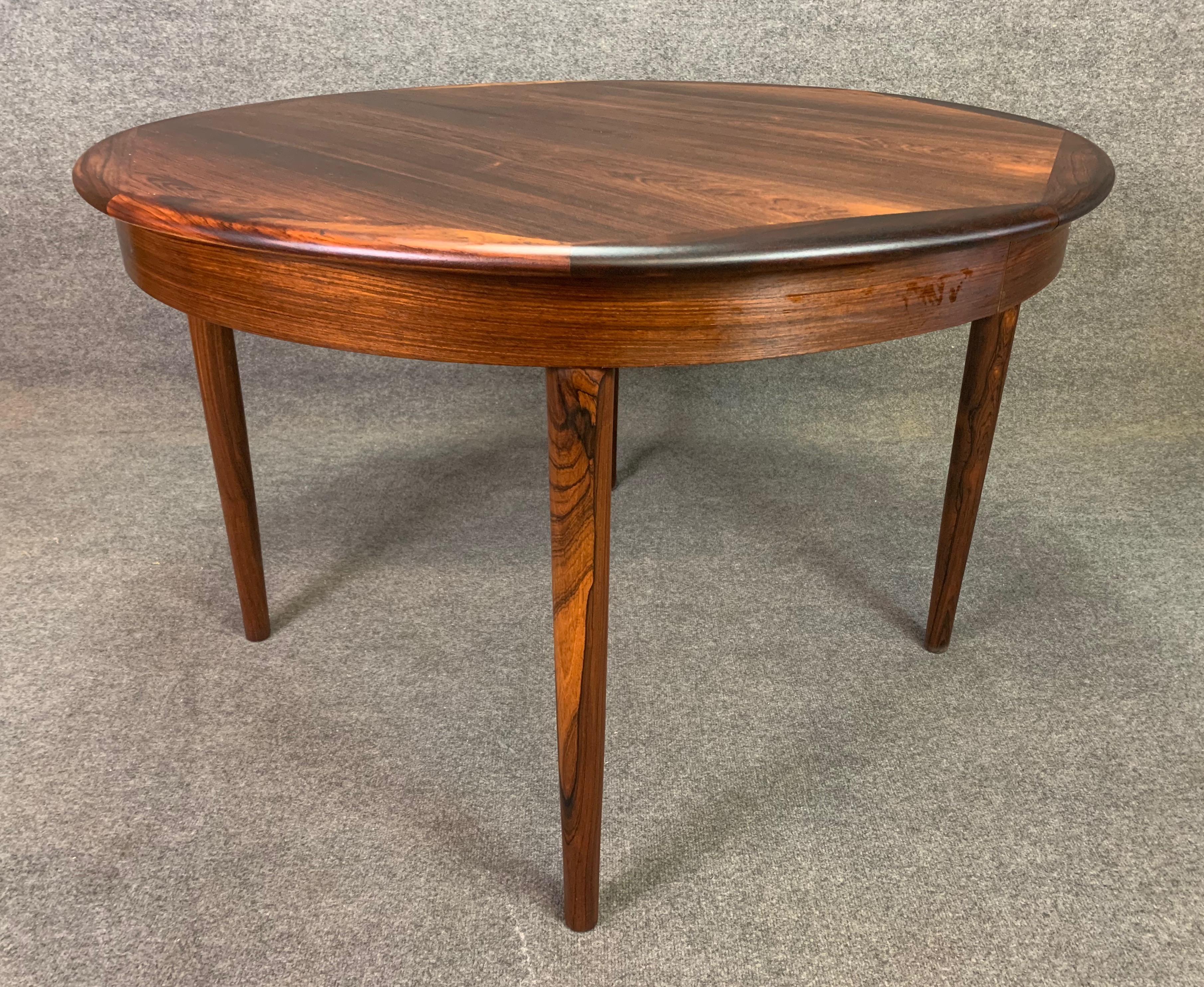 Here is a beautiful 1960s Scandinavian Modern dining table in rosewood recently imported from Denmark to California before its refinishing.
This exquisite dining table features a vibrant rosewood grain, three leaves and four solid wood tapered