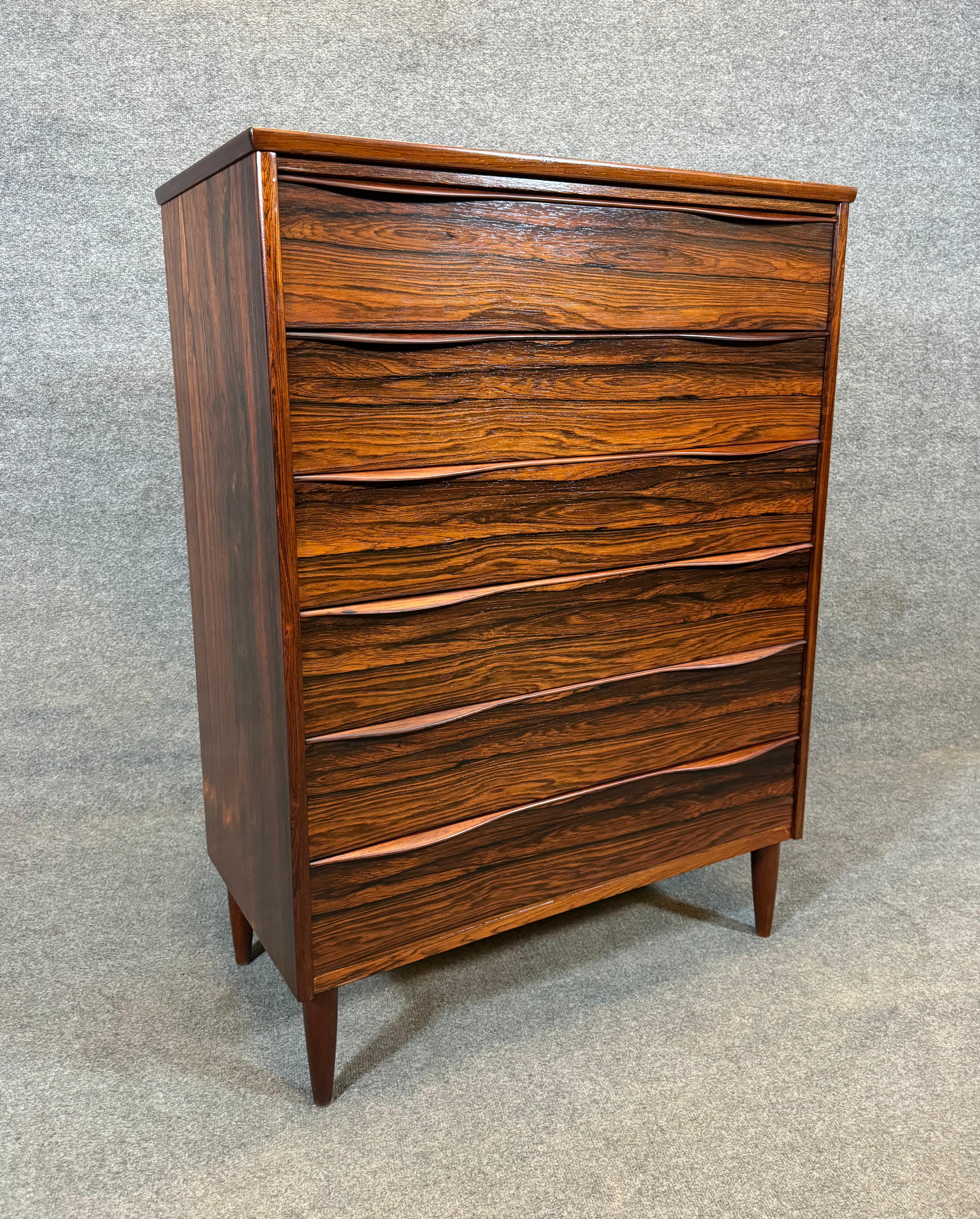 Here is a very special scandinavian modern chest of drawer dresser in rosewood manufactured in Denmark in the 1960's. This beautiful piece, recently imported from Europe to California before its refinishing, features highly figurative wood grain