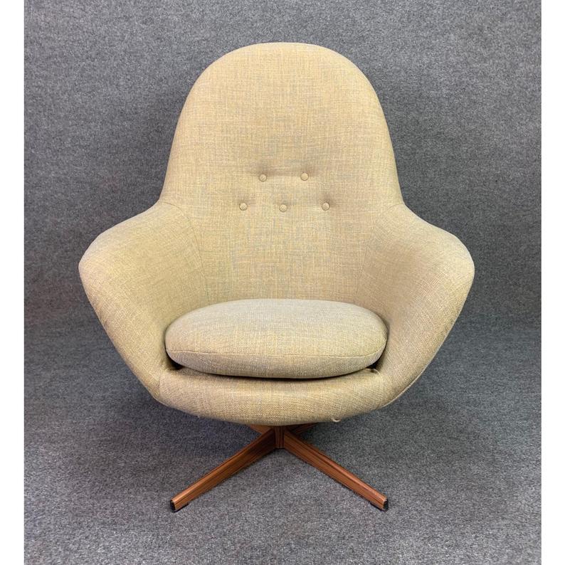 Here is a beautiful 1960s scandinavian modern high back swivel easy chair recently imported from Denmark to California.
This sculptural and comfortable chair features a brand new period correct textured tufted upholstery in grey-ish/beige and a