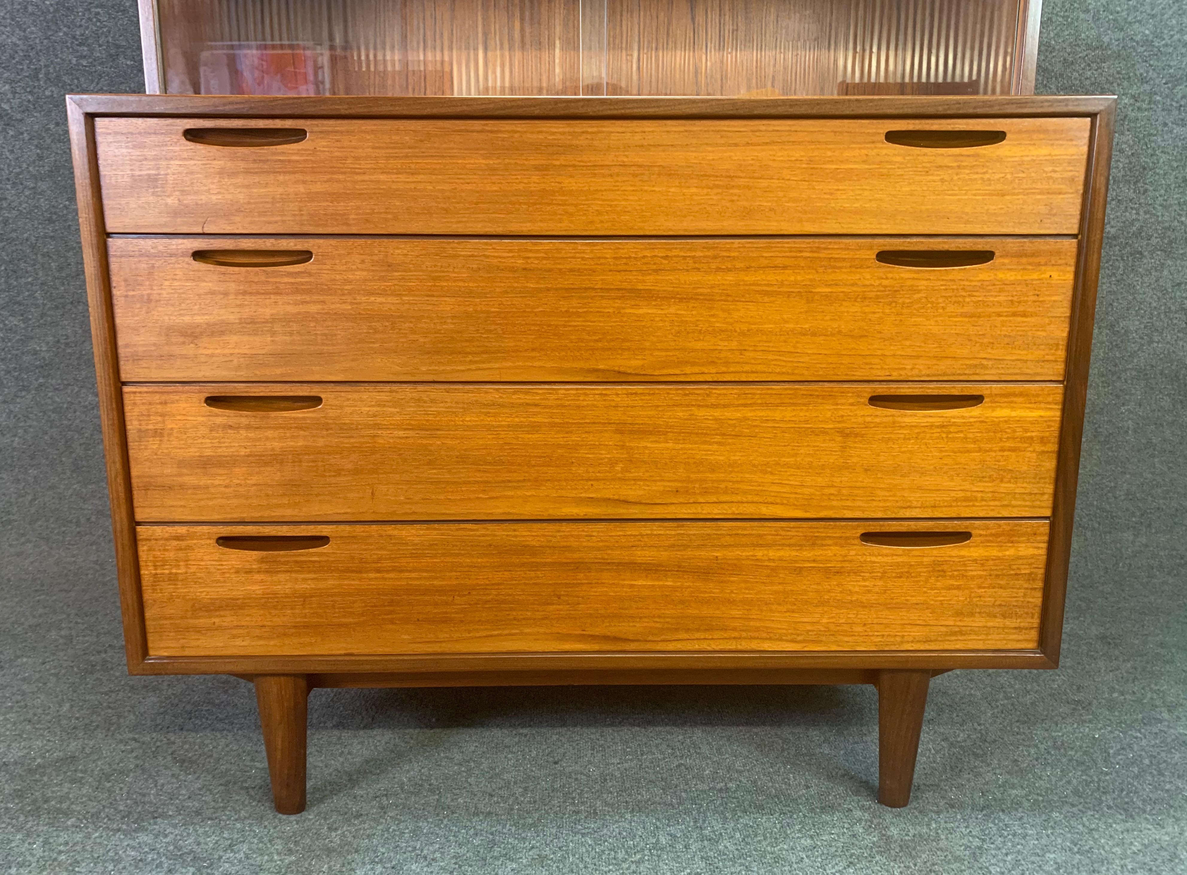 Here is a beautiful display cabinet - chest of drawers in teak designed by master Kofod Larsen and manufactured by J. Clausen - Brande Mobelfabrik.
This rare specimen was ordered in Denmark in the late 50's by a family stationed in Germany on a