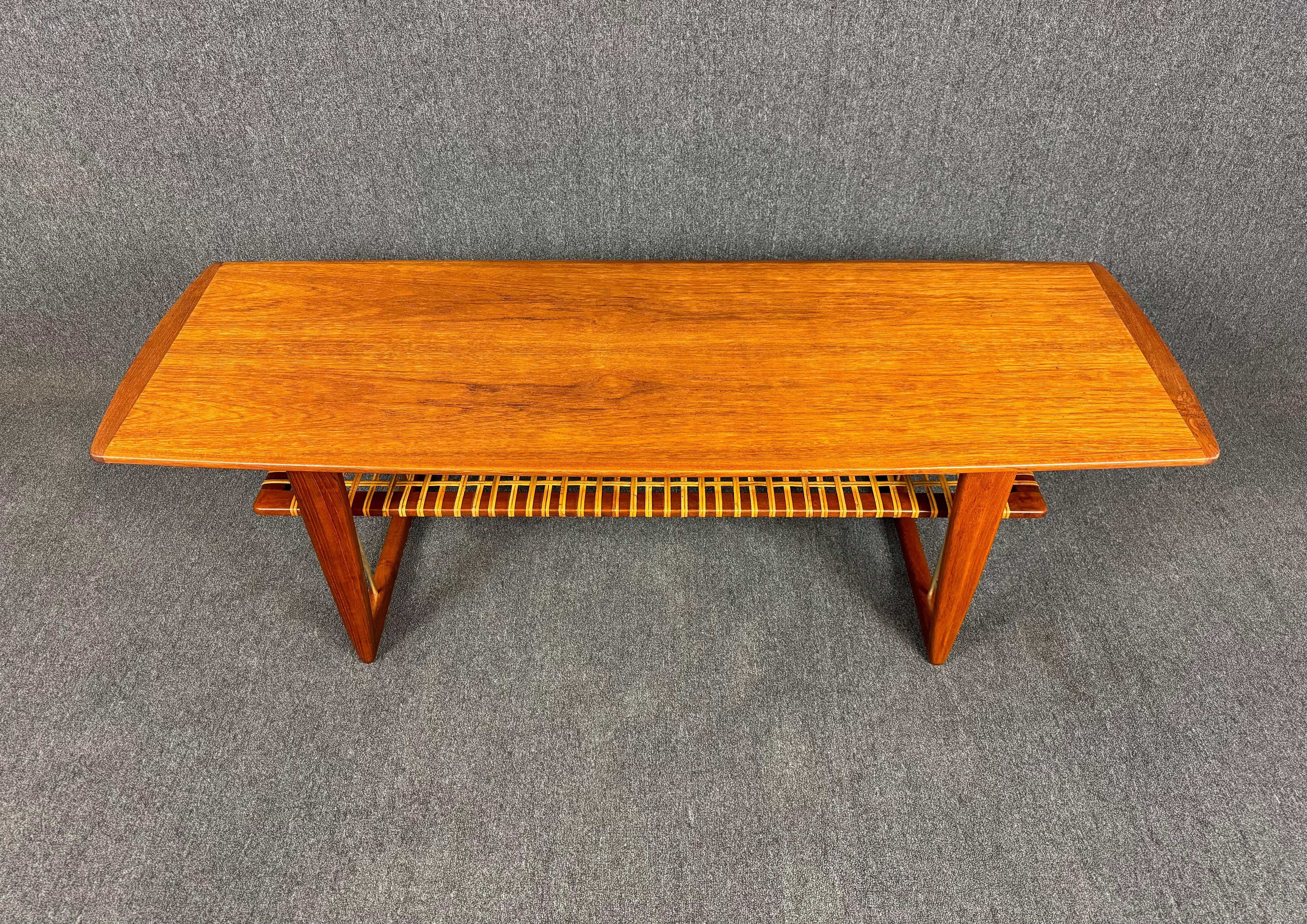 Here is a beautiful scandinavian modern cocktail table in teak wood manufactured in Denmark in the 1960's.
This lovely coffee table, recently imported from Europe to California before its refinishing, features a large surf shaped table top showing