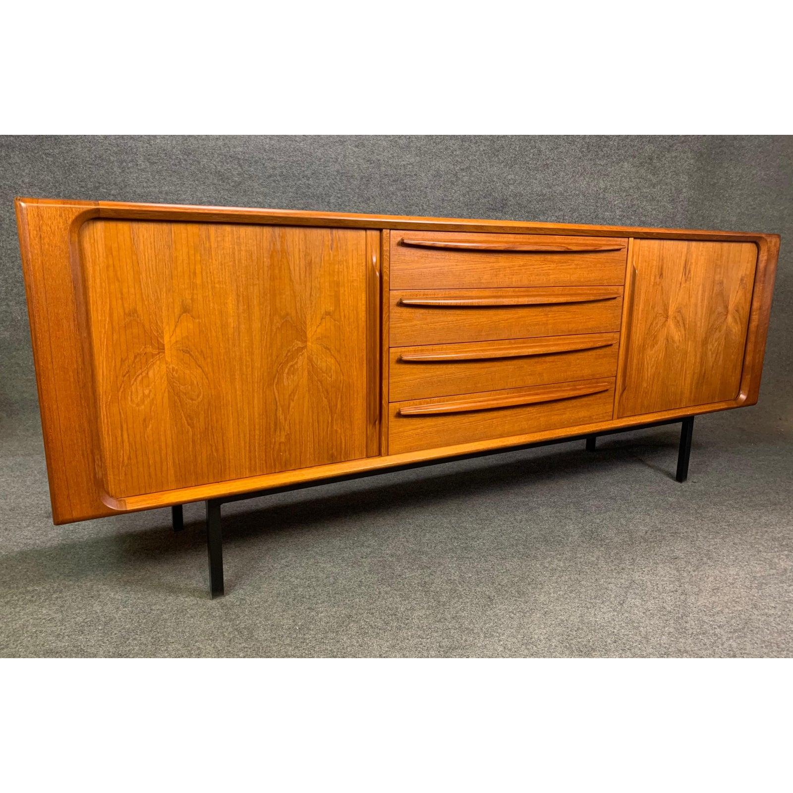 Here is a beautiful Scandinavian Modern sideboard in teak manufactured by Bernhard Pedersen & Son in Denmark in the 1960s.
This large credenza, cleaned up and oiled, features a vibrant wood grain, a central bank of four dove tail built drawers