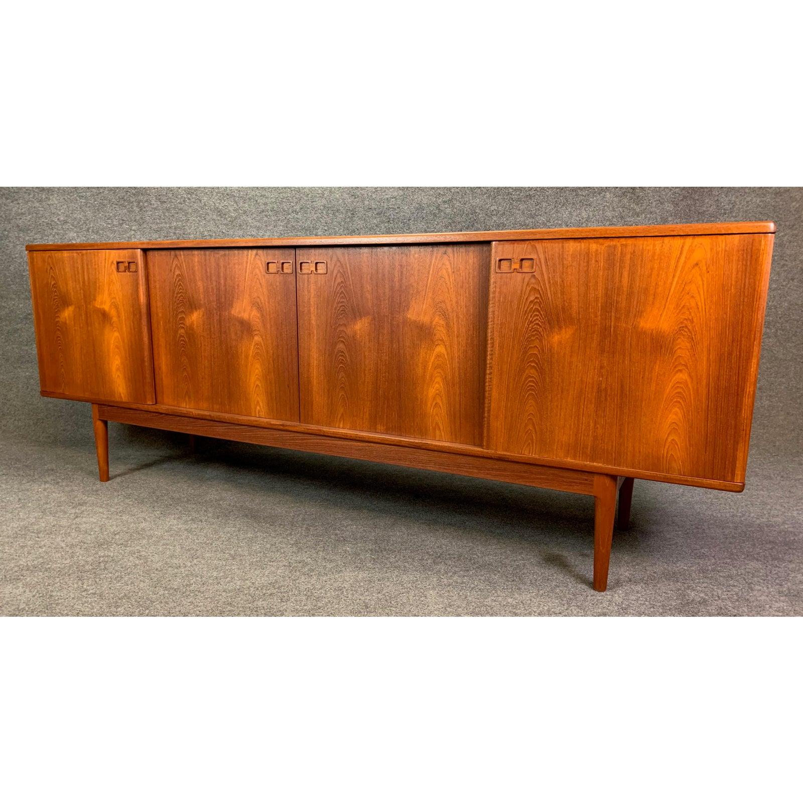 Here is a beautiful 1960s Scandinavian Modern sideboard in teak wood by Christian Linneberg, Denmark.
This long credenza, recently imported from Copenhagen to California before its restoration, features a vibrant wood grain and four sliding doors