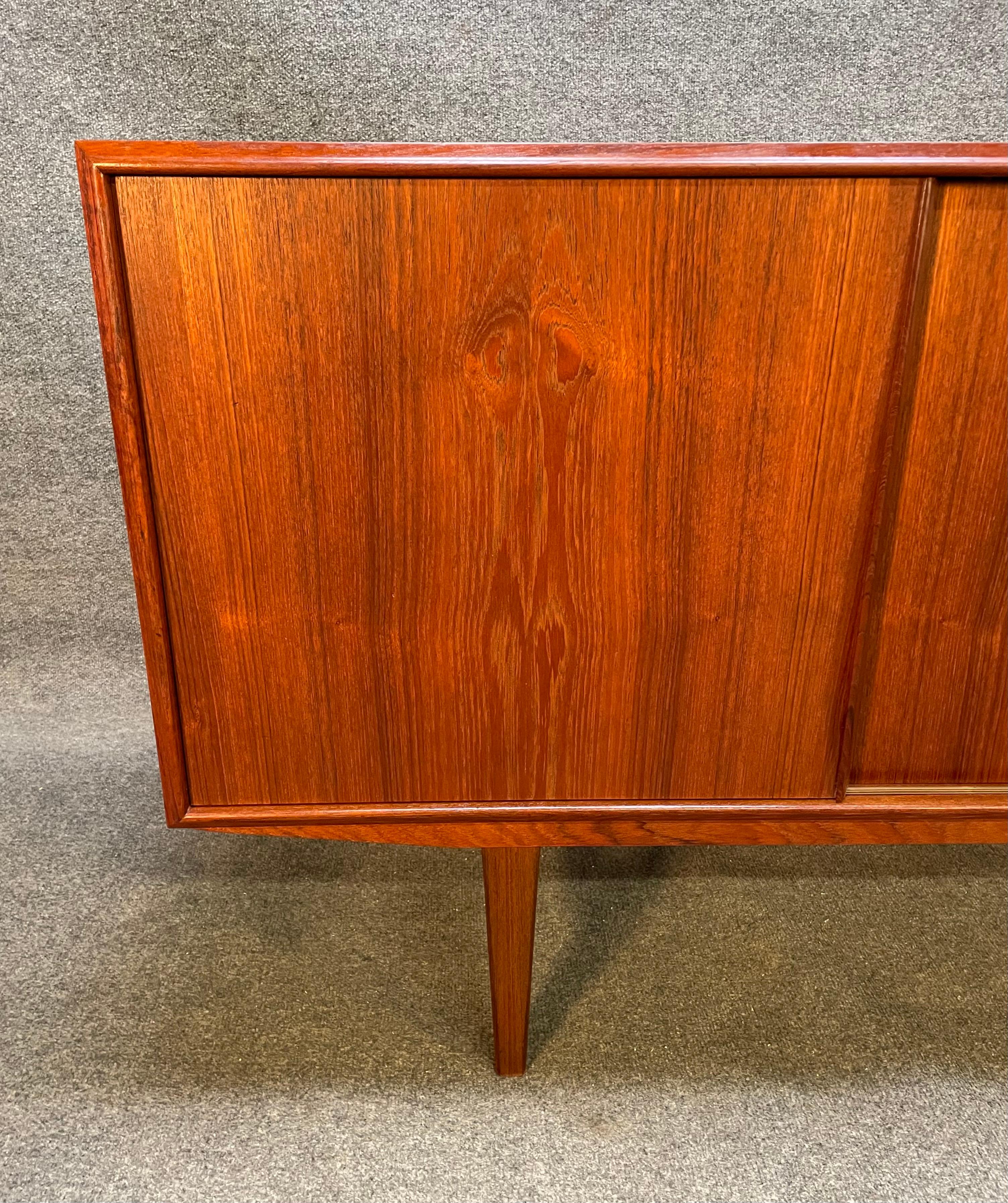 Here is a beautiful scandinavian modern teak credenza designed by E.W Bach manufactured in Denmark in the 1960's by Sejling Skabe.
This exquisite piece, recently imported from Europe to California before its refinishing, features vibrant wood