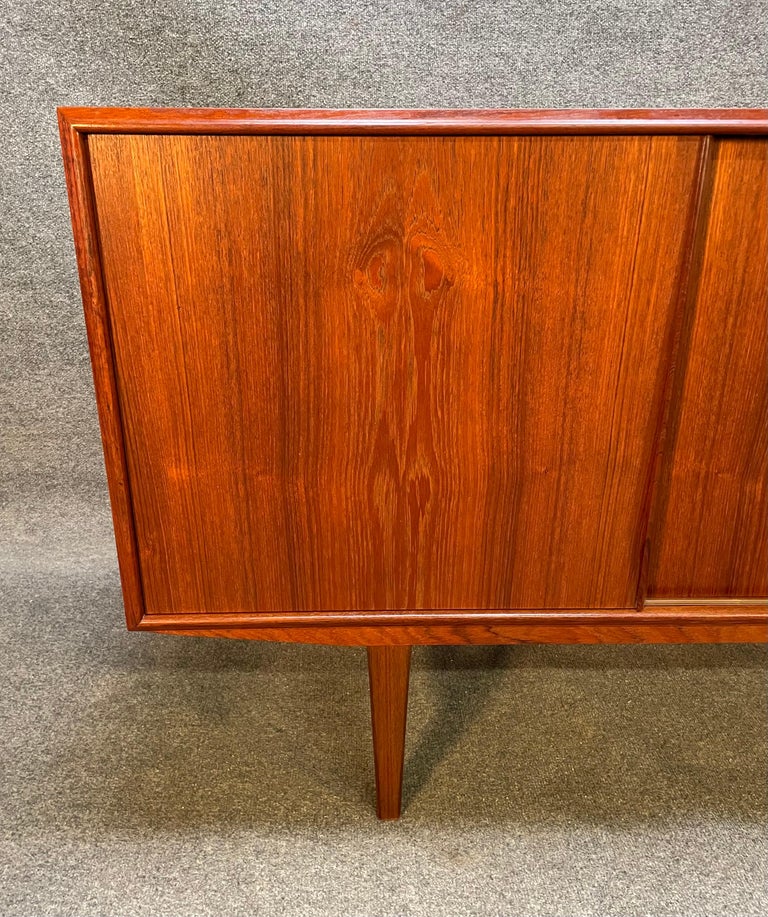 Here is a beautiful scandinavian modern teak credenza designed by E.W Bach manufactured in Denmark in the 1960's by Sejling Skabe.
This exquisite piece, recently imported from Europe to California before its refinishing, features vibrant wood