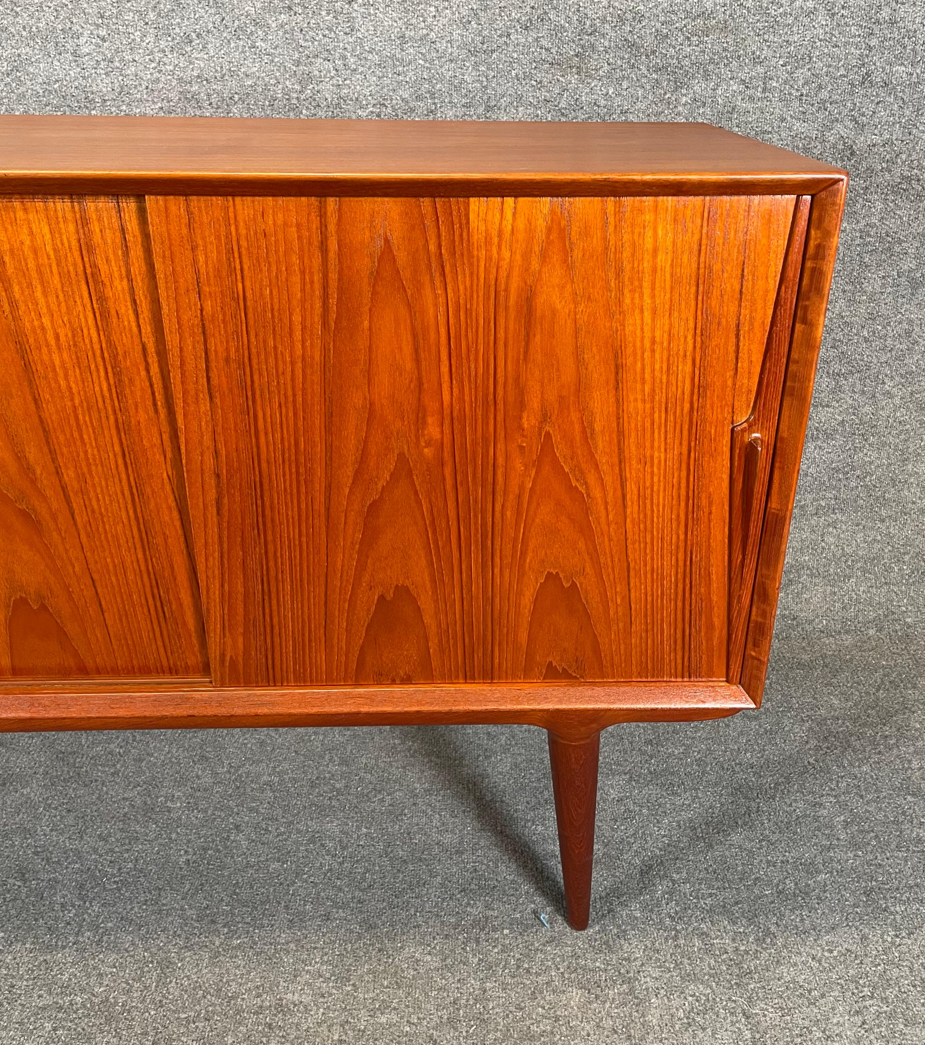 Here is a beautiful and rare Scandinavian modern sideboard in teak designed by Gunni Omann and manufactured by Omann Jun in Denmark in the 1960's.
This lovely case piece, recently imported from Europe to California before its refinishing, features a