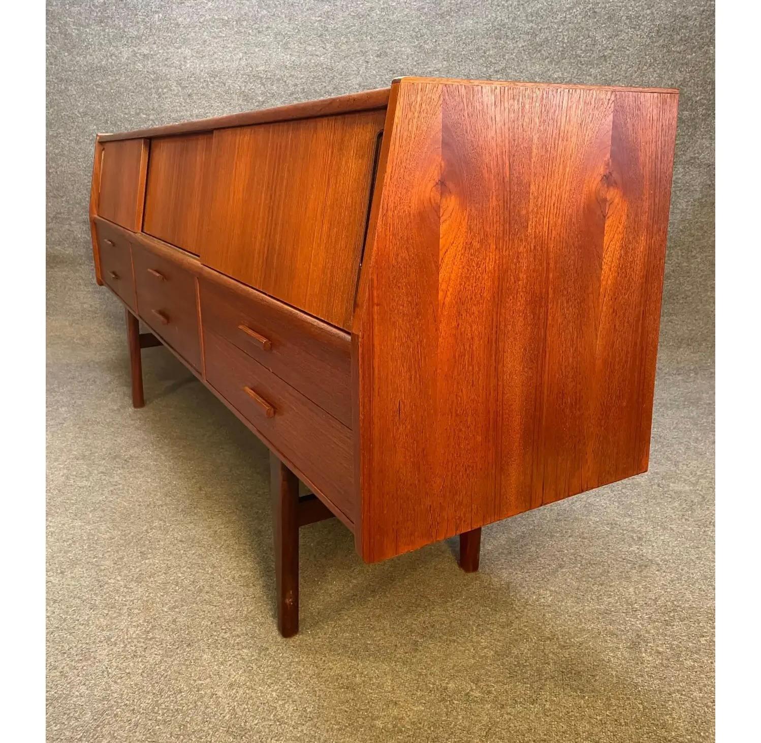 Here's a beautiful 1960's Scandinavian modern sideboard in teak recently imported from Denmark to Copenhagen before its refinishing.
This credenza features a vibrant wood grain, three sliding doors at its top revealing storage cubbies + two drawers