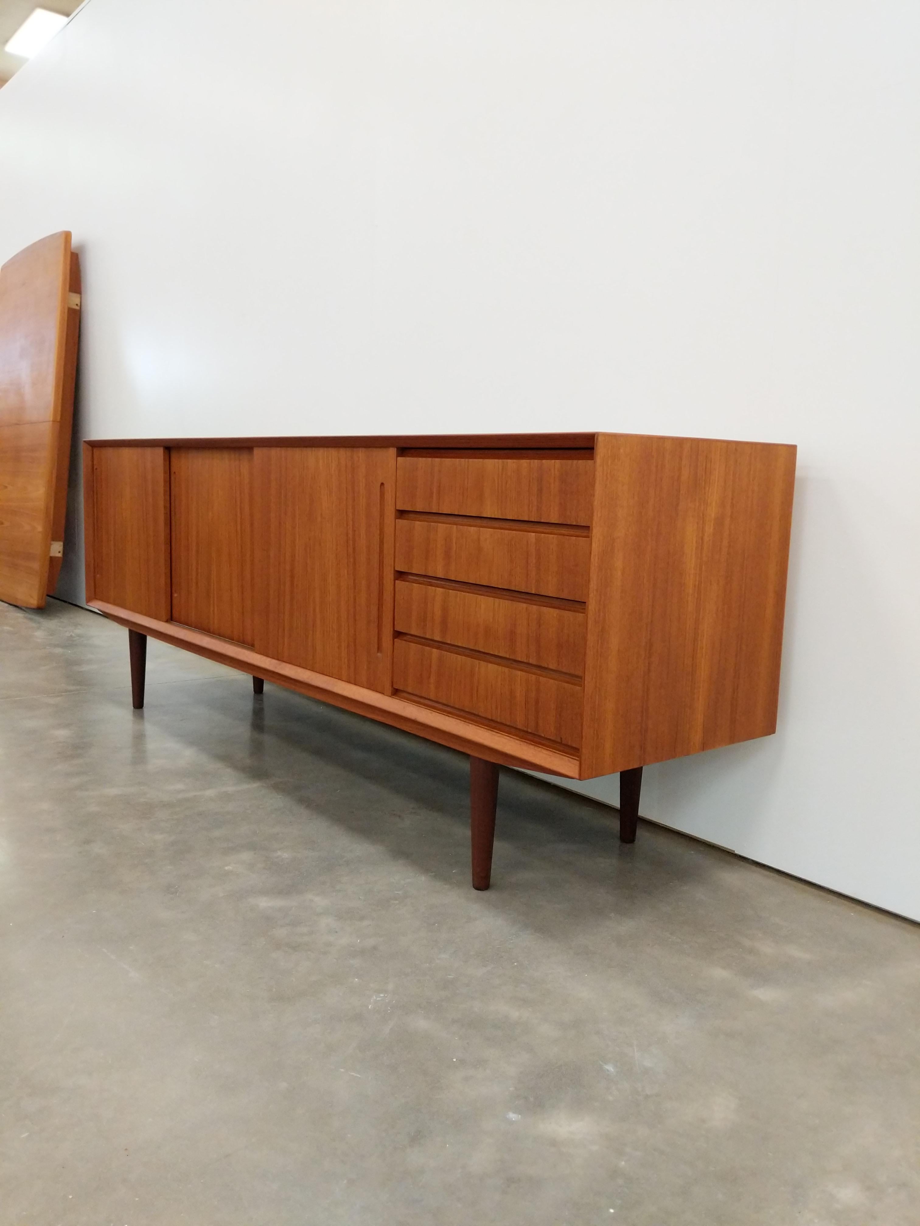 Authentic vintage Danish / Scandinavian mid century modern teak credenza / sideboard / media console.

The interior shelves are removable, allowing the piece to accommodate 12 inch records.

This piece is in excellent refinished condition with very