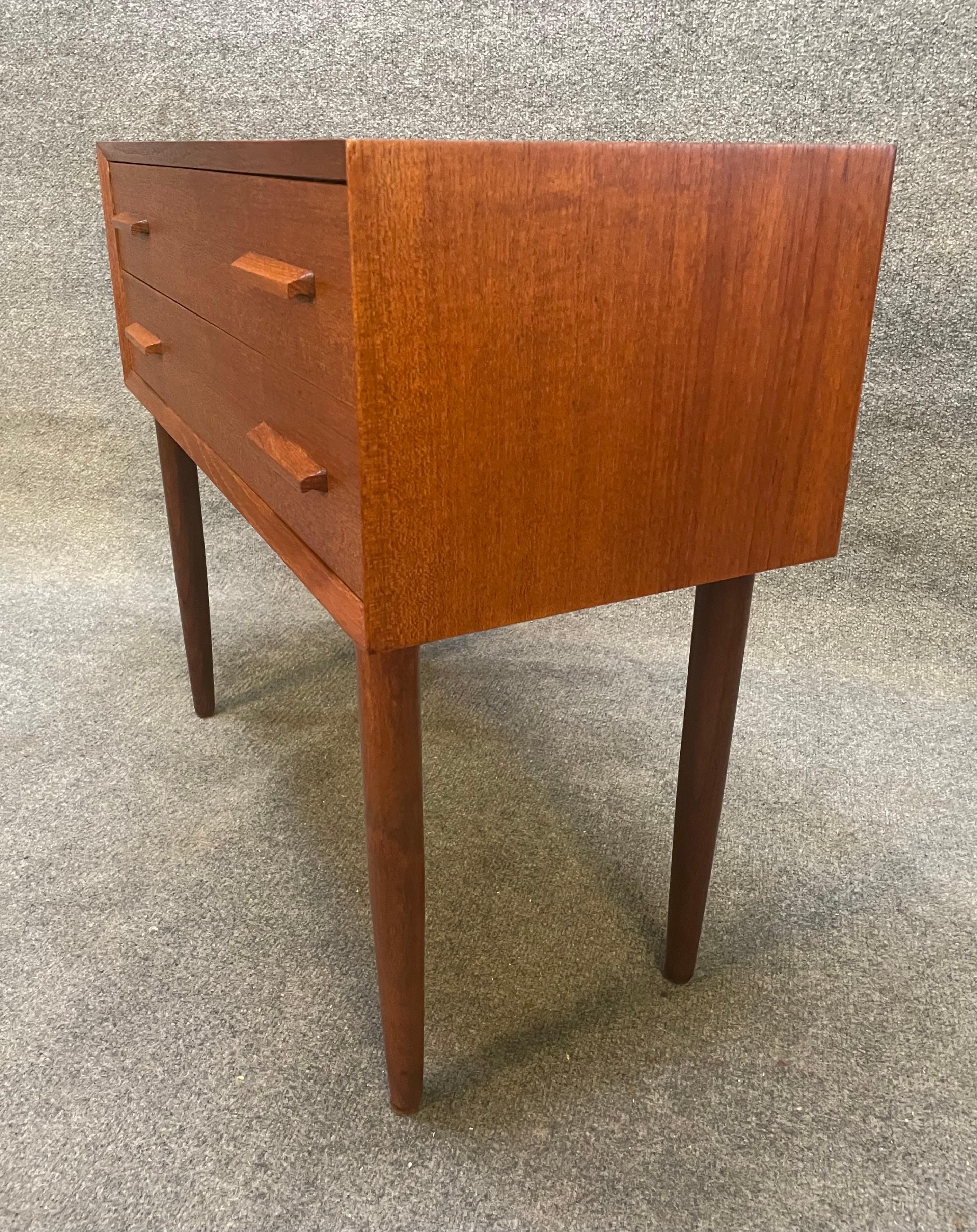 Here is a beautiful scandinavian modern entry chest - side table in teak wood manufactured in Denmark in the 1960's.
This exquisite case piece, recently imported from Europe to California before its refinishing, features a vibrant wood grain, two