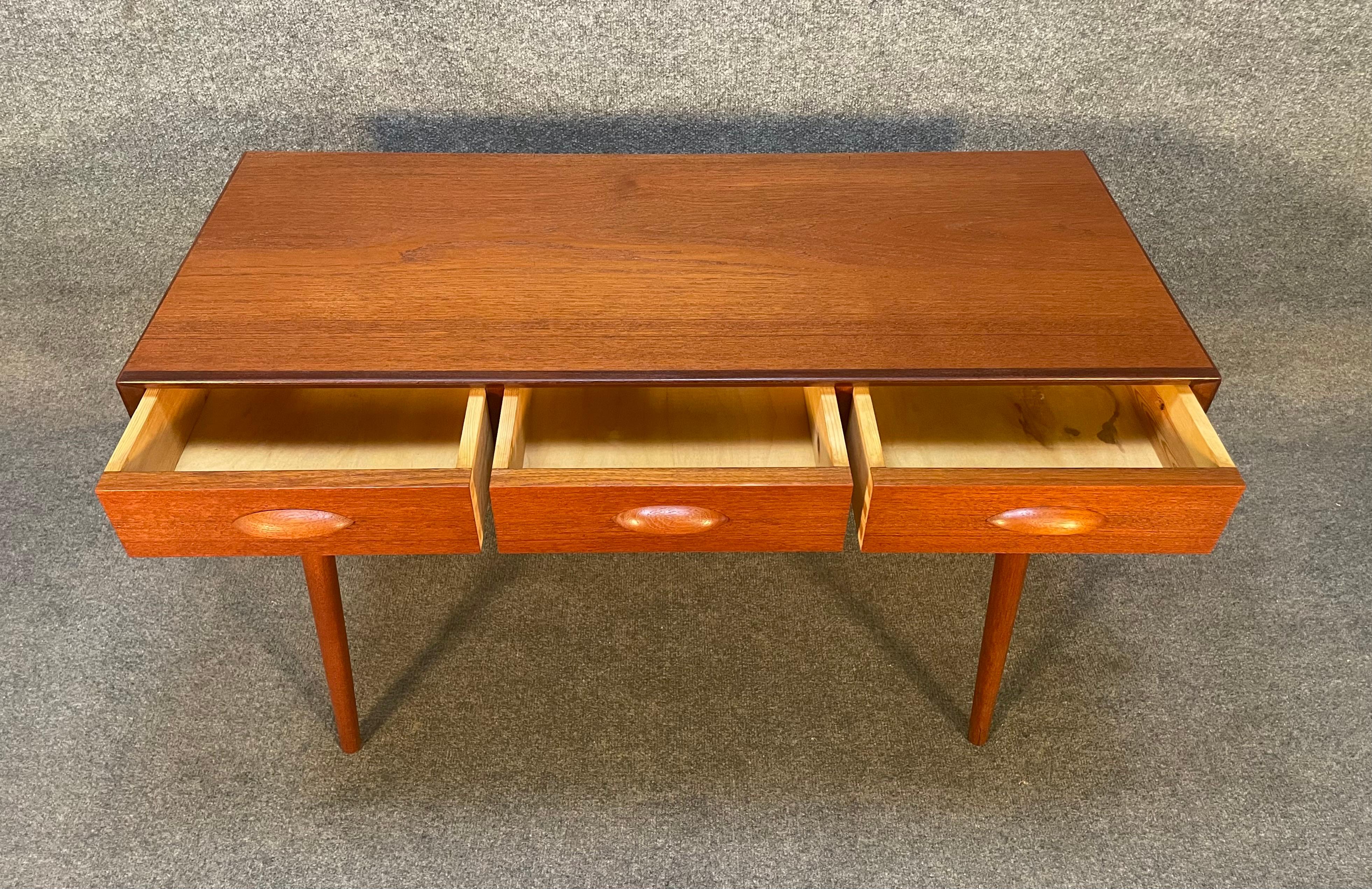 Here is a beautiful Scandinavian modern teak entry way console table manufactured in Denmark in the 1960's.
This lovely piece, recently imported from Europe to California before its refinishing, features a vibrant wood grain, three dove tail built