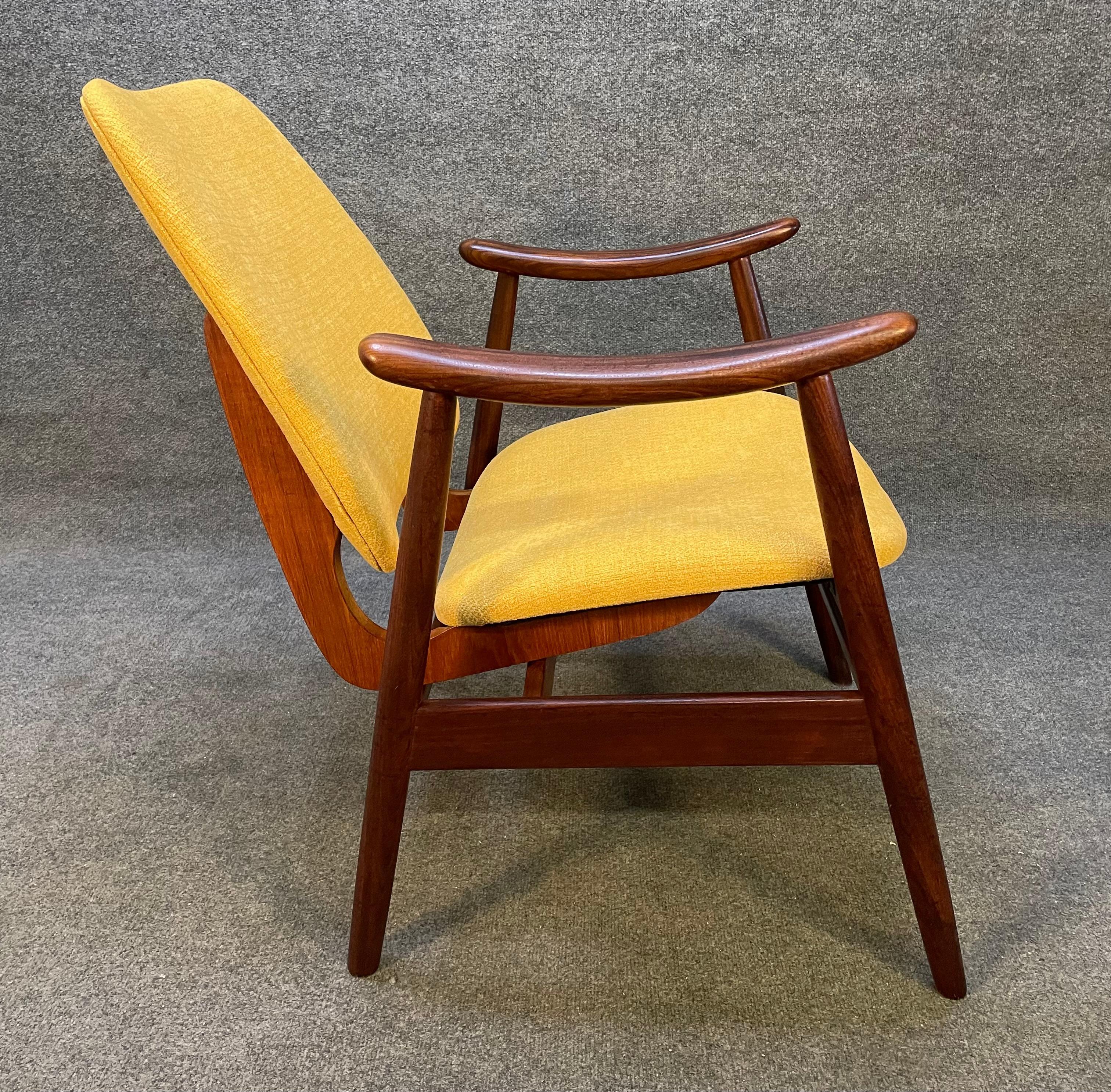 Here is a beautiful 1960's scandinavian modern easy chair in afromasia teak recently imported from Norway to California before its refinishing.
This comfortable chair features a brand new yellow textured upholstery contrasting with an organically