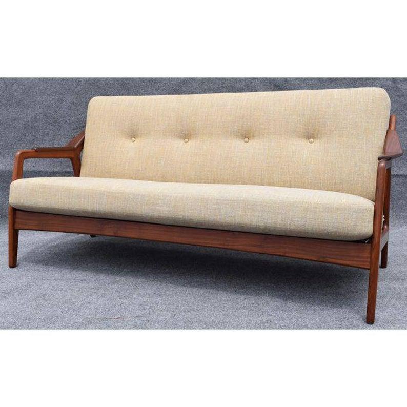 Here is a beautiful sofa designed by H. Brockmann-Petersen in Denmark in the 1960's and recently imported to California.

It features a solid afromasia teak frame with slats supporting the back cushion and metal springs supporting the seat