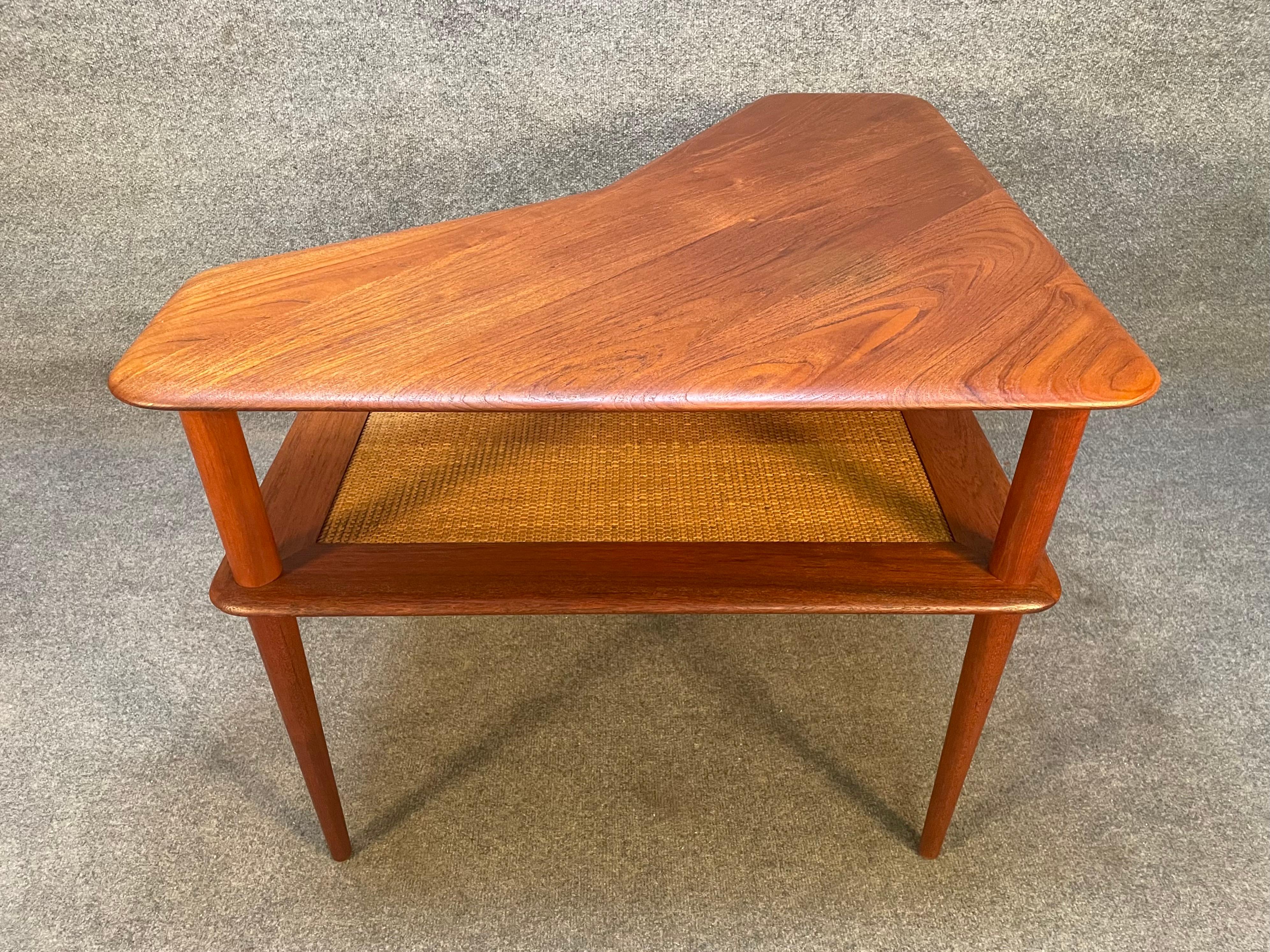 Here is a beautiful Scandinavian modern end table in teak designed by Peter Hvidt & Orlaa Molgaard and manufactured by France and Son in Denmark in the 1960's.
This exquisite corner table, recently imported from Europe to California become its