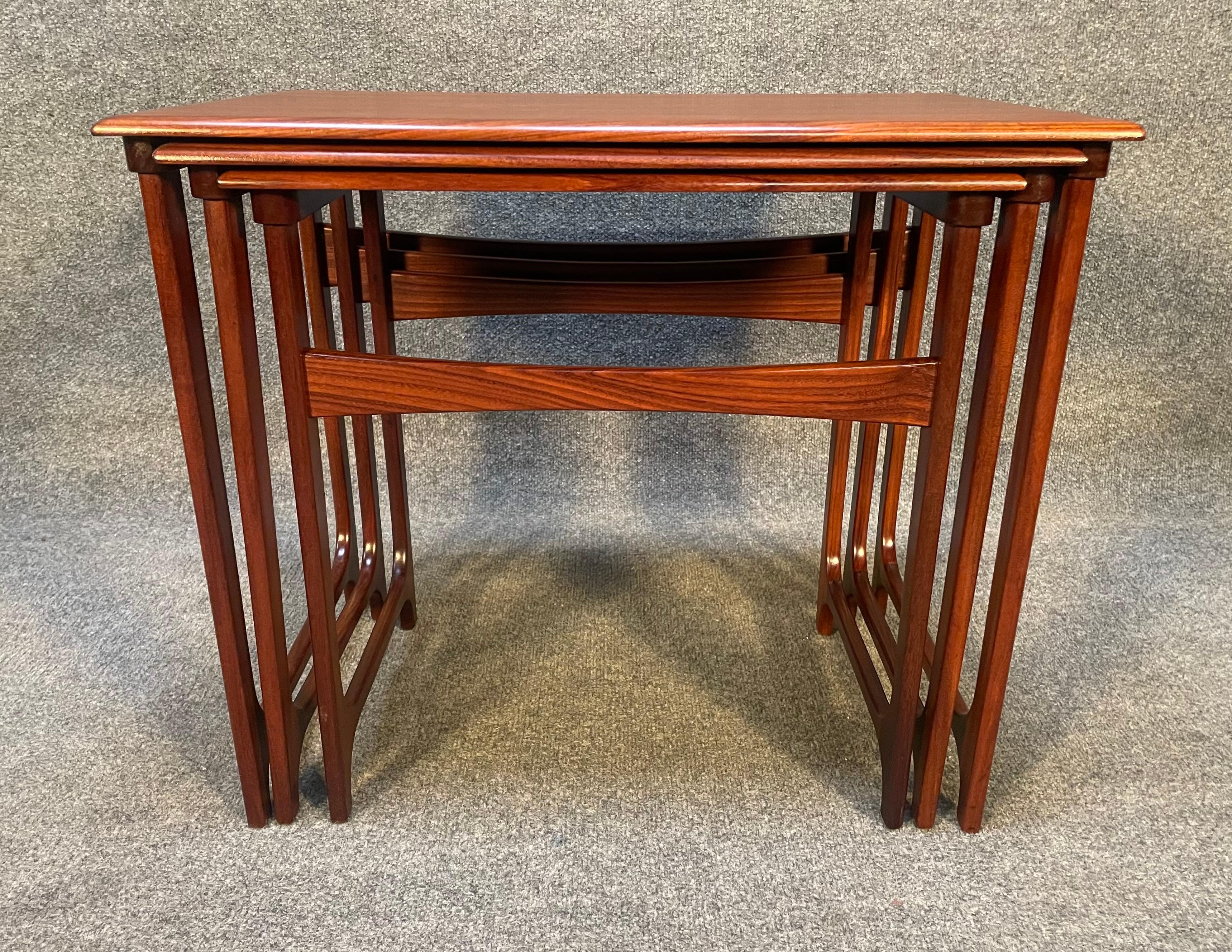 Here is a beautiful set of three Scandinavian modern teak nesting tables manufactured by BC Mobler in Denmark in the 1960s.
This exquisite set, recently imported from Europe to California before its refinishing, features a vibrant wood grain, and a