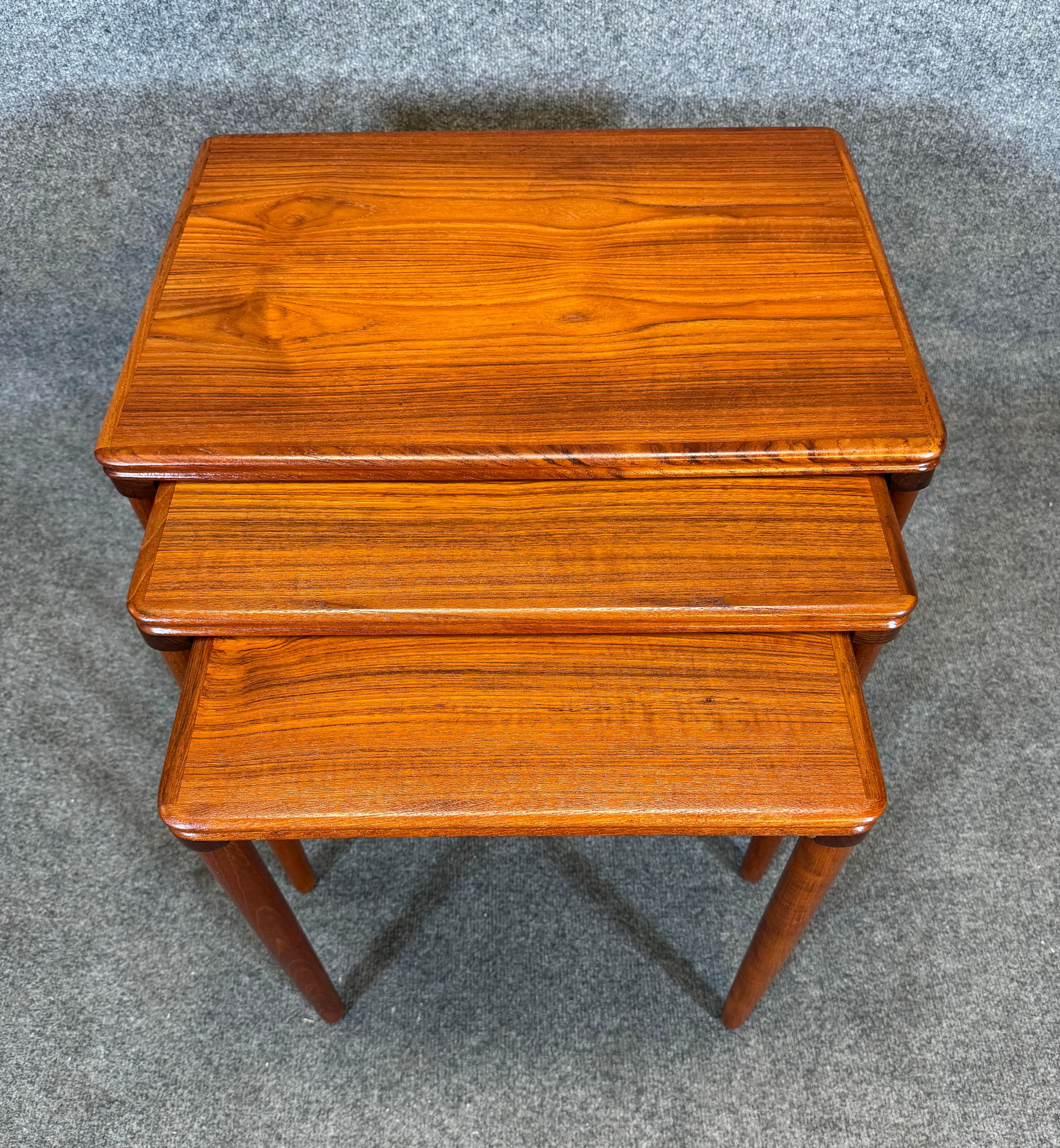 Here is a beautiful set of three scandinavian modern nesting tables in teak manufactured in Denmark in the 1960's.
These tables, recently imported from Europe to California before their refinishing, feature a vibrant wood grain and tapered legs in