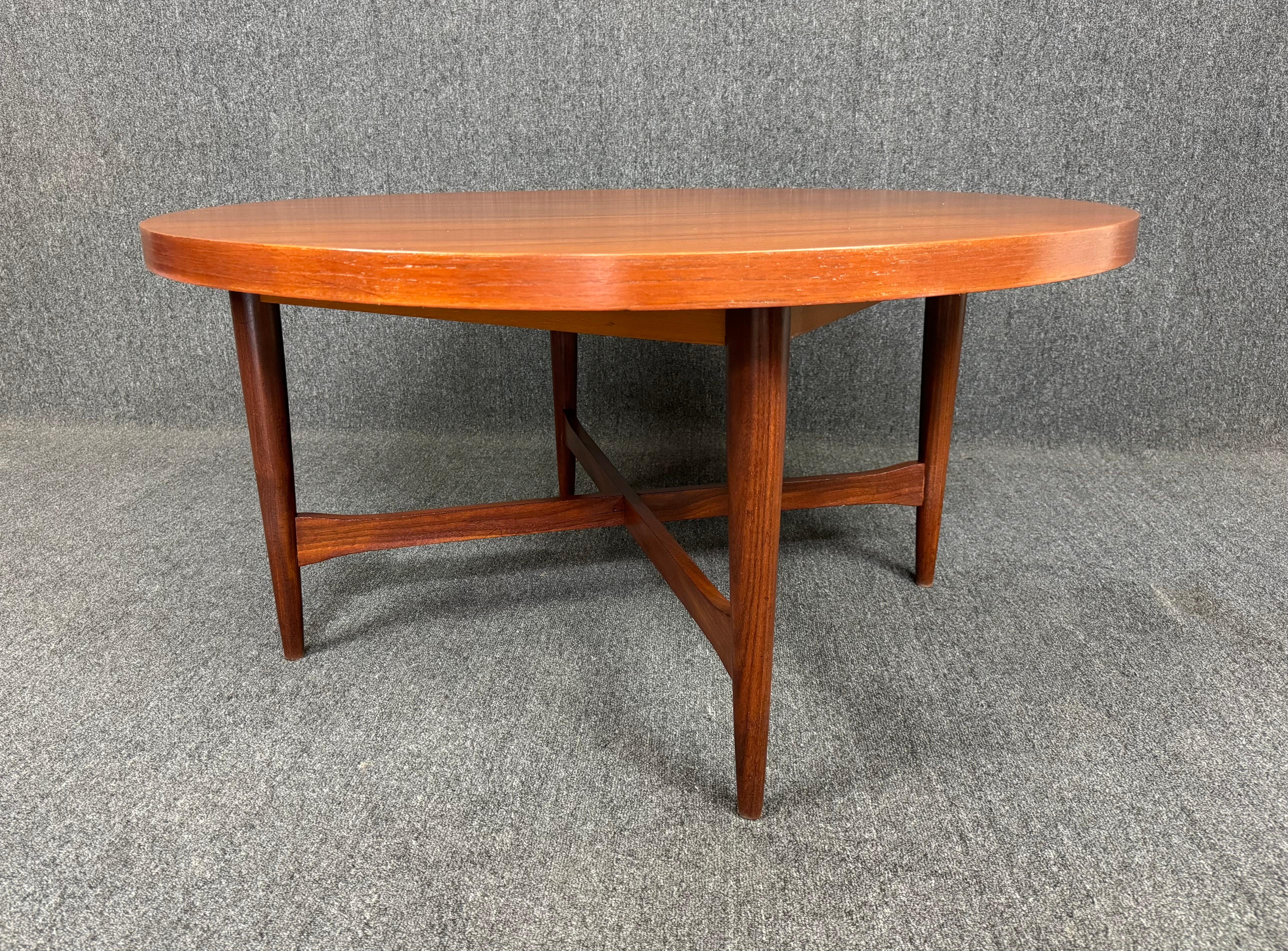 Here is a lovely scandinavian modern cocktail table in teak manufactured in Denmark inn the 1960's. This beautiful table, recently imported from Europe to California before its refinishing, features a vibrant wood grain on its circular table top