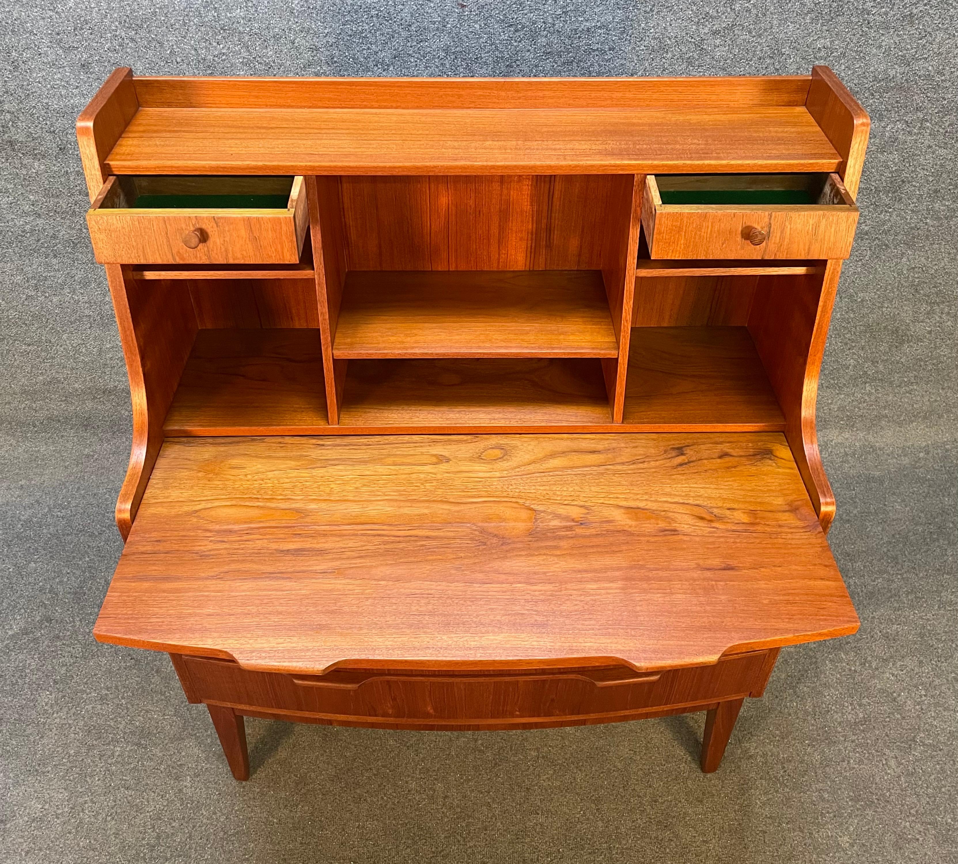 Here is a beautiful Scandinavian modern teak secretary desk manufactured by Christian Larsen in Denmark in the 1960's.
This exquisite piece, recently imported from Europe to California before its refinishing, features a vibrant wood grain, a bowed