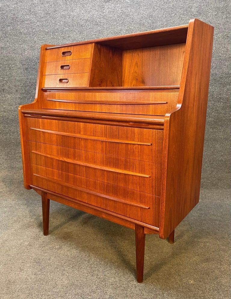 Here is a beautiful Scandinavian secretary desk in teak manufactured by Gunnar Falsig in Denmark in the 1960s. This exquisite piece, recently imported from Copenhagen to California before its refinishing, features a vibrant wood grain with many