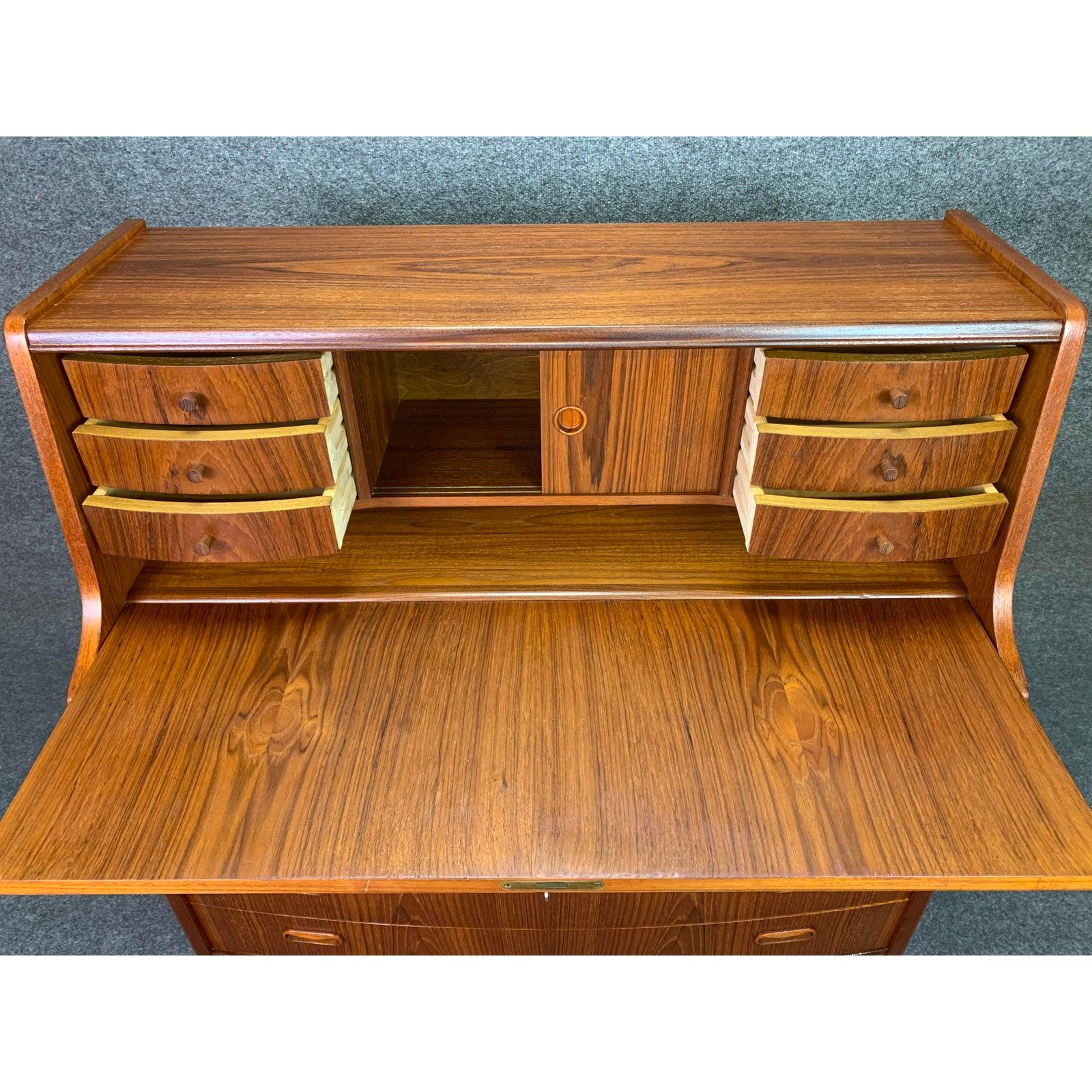 Here is a beautiful Scandinavian Modern secretary desk - dresser in teak wood manufactured in Denmark by PMJ Mobelfabrik in the 1960s.
This lovely piece, recently imported from Copenhagen to California before its restoration, features a vibrant