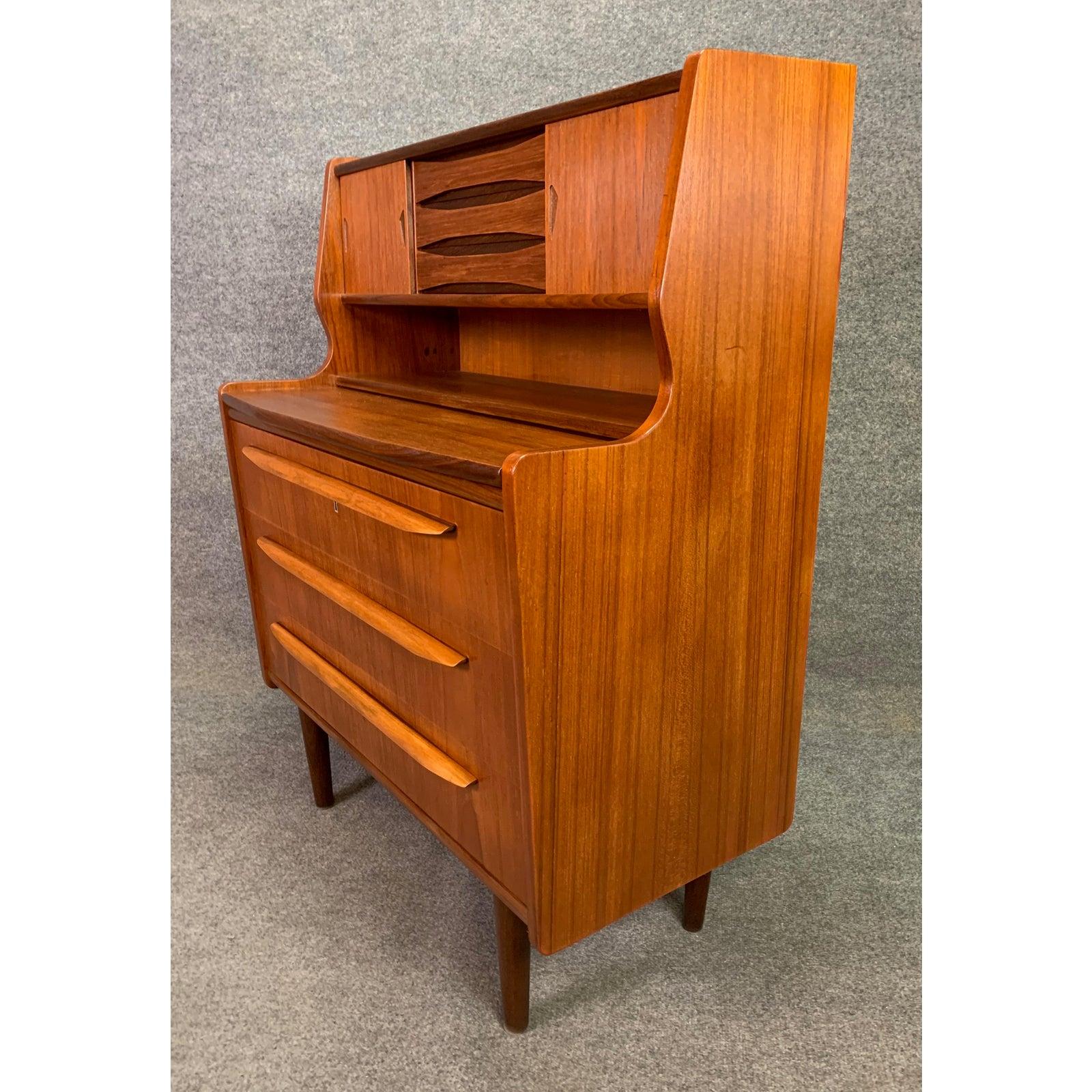 Here is a beautiful 1960s Scandinavian Modern secretary in teak recently imported from Europe to California before its refinishing.
This lovely case piece features on its top two sliding doors revealing two small storage cubbies and a central bank