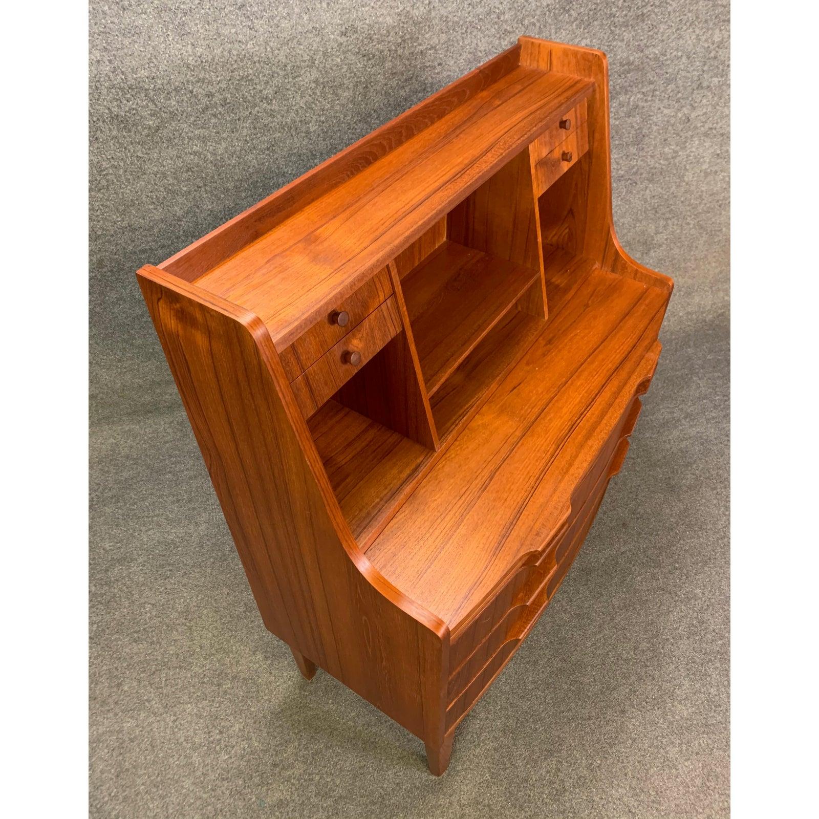 Here's a beautiful Scandinavian Modern secretary desk manufactured in Denmark in the 1960s recently imported to California.
This special piece, with its vibrant wood grain, features on its upper side multiple storage cubbies, four small drawers and