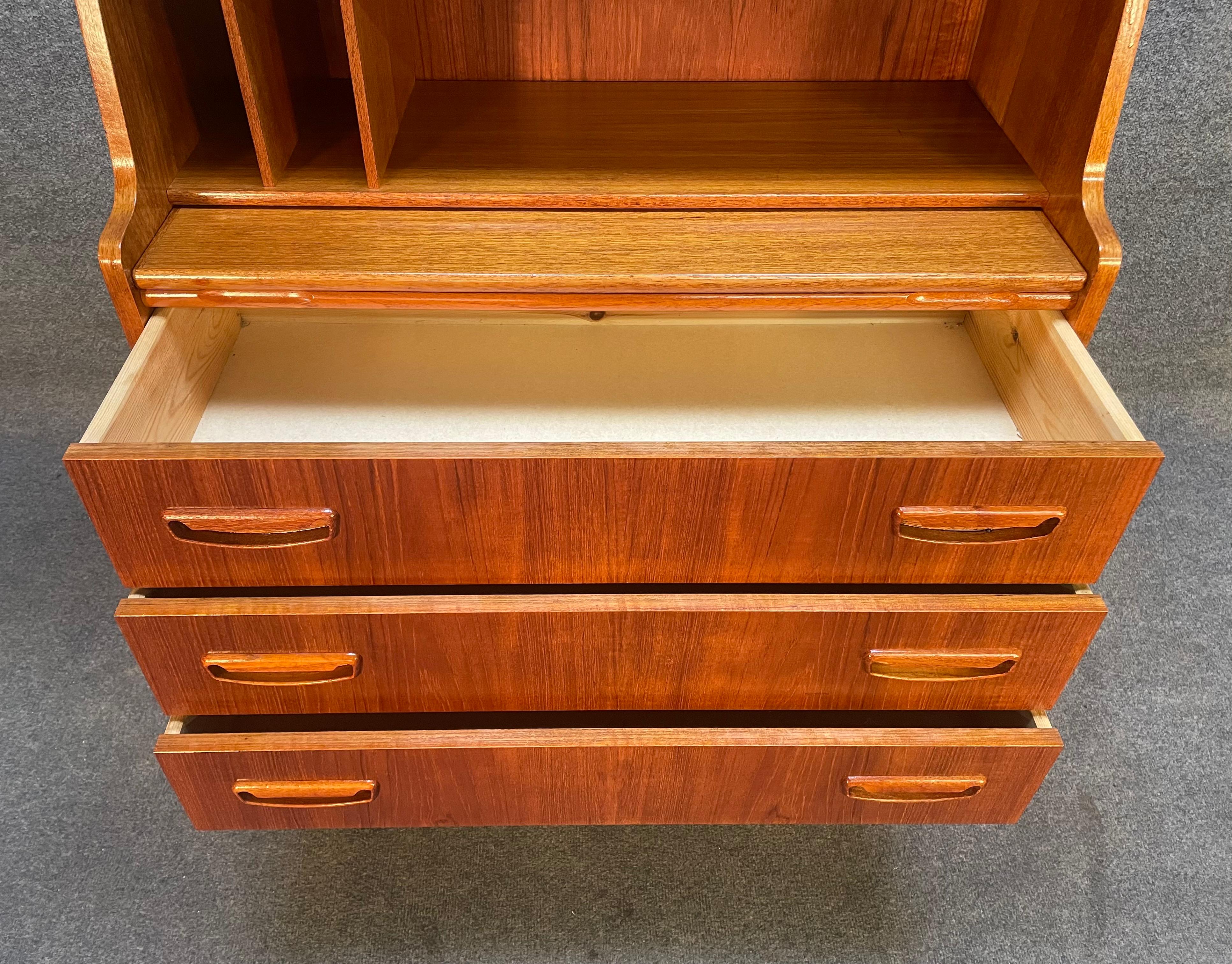 Here is a lovely petite Scandinavian modern secretary isn teak wood manufactured in Denmark in the 1960's.
This charming piece, recently imported from Europe to California before its refinishing, features a vibrant wood grain, two small top