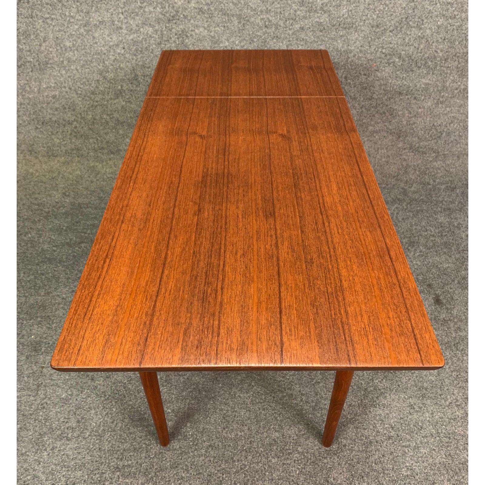 Here is a beautiful Scandinavian Modern sewing table in teak wood recently imported from Denmark to California before its restoration.
This lovely end table features a slide top with a drop leaf, a drawer with compartments and a pullout wicker