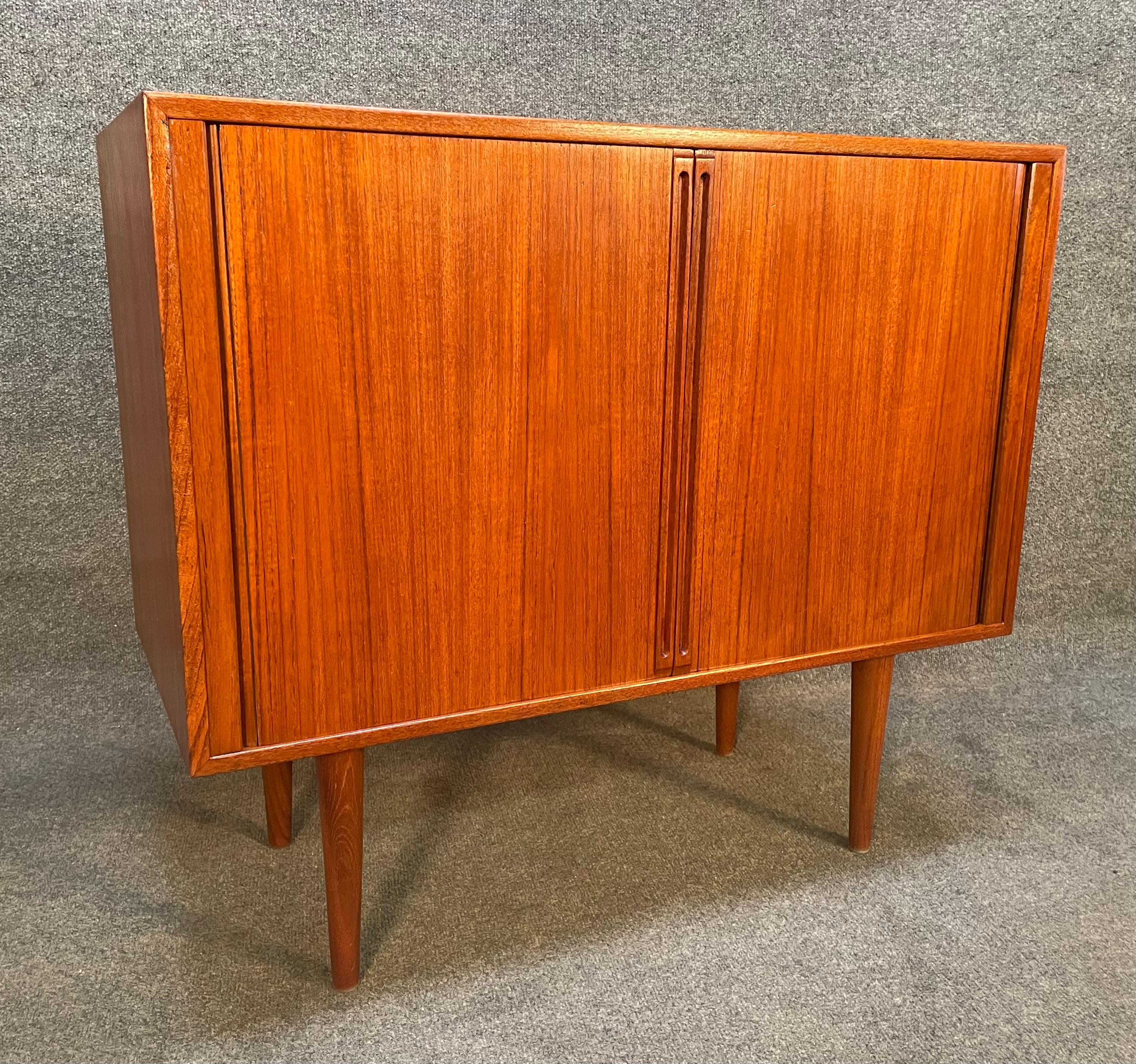 Here is a beautiful Scandinavian modern teak compact credenza designed by Kai Kristiansen and manufactured by Feldballes Mobelfabrik in Denmark in the 1960's.
This lovely cabinet, recently imported from Europe to California before its refinishing,