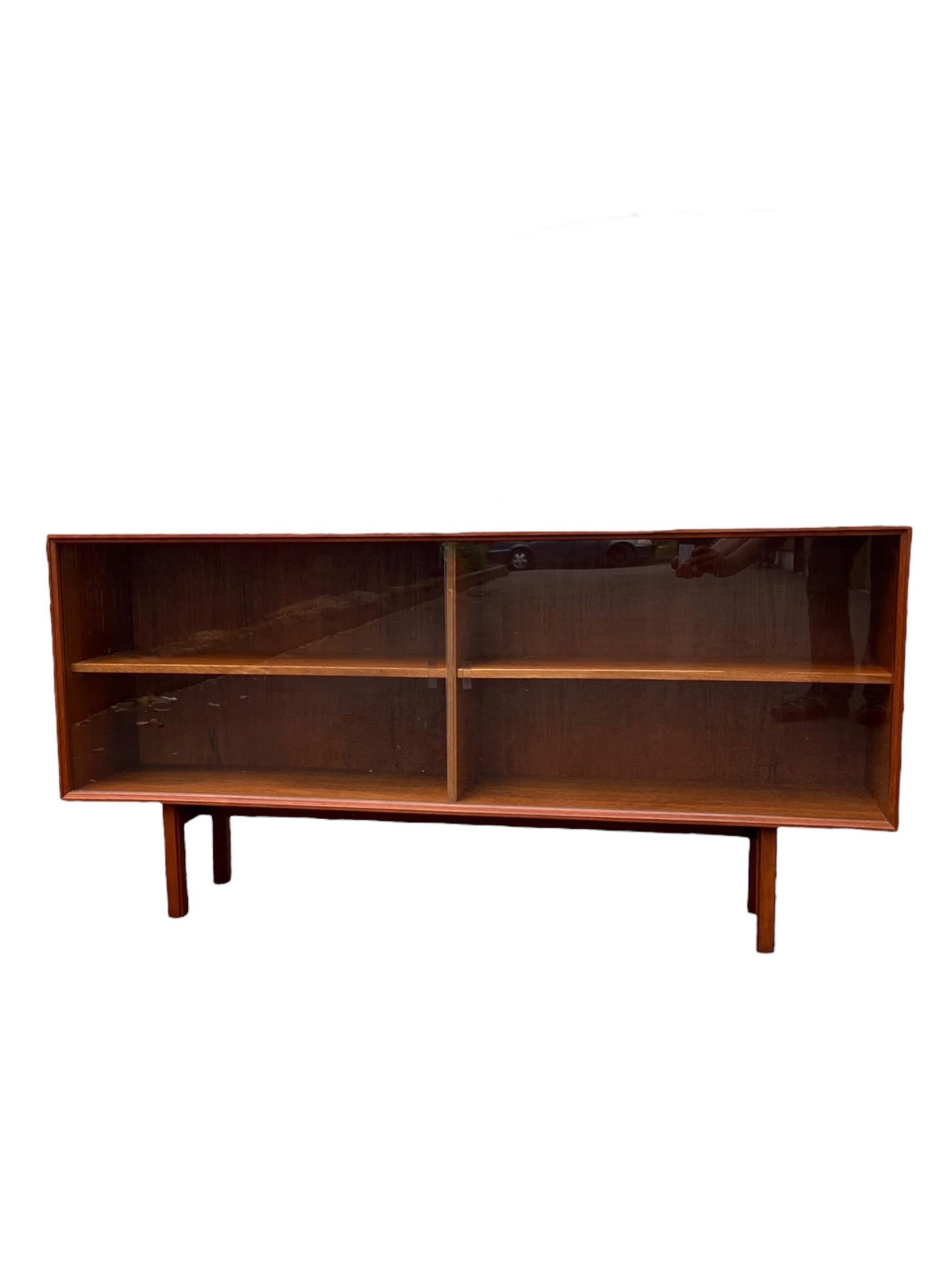 Vintage Danish Mid Century Modern Teak Wood Book Shelf Display Cabinet Adjustable Shelf.

Dimensions. 60 W ; 12 1/2 D ; 29 H
Inside (Right ). 29 1/2 W ; 11 1/2 D ; 18 3/4 H
Inside (Left ). 29 1/2 W ; 11 1/2 D ; 18 3/4 H