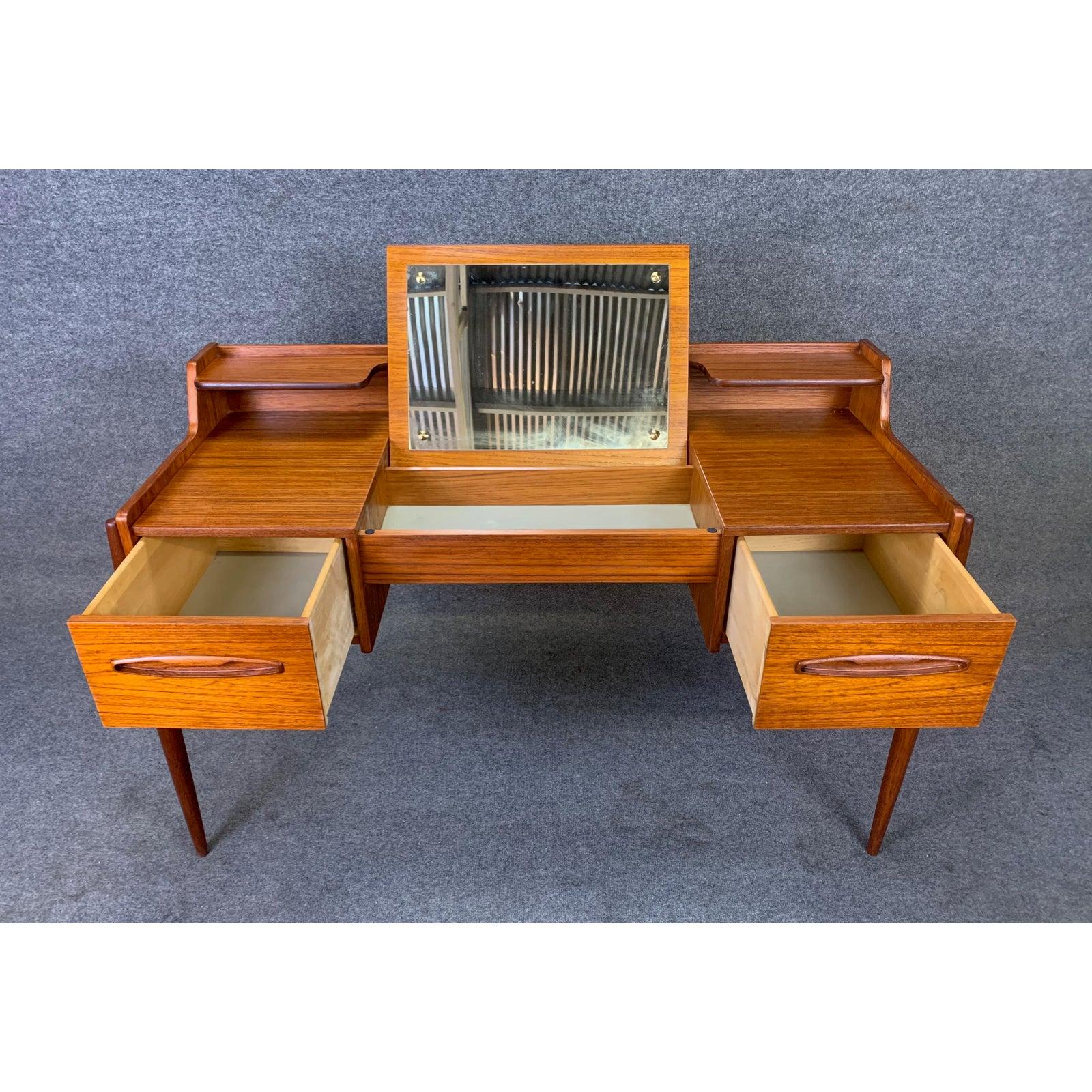 Here is a beautiful Scandinavian Modern teak desk manufactured in Denmark the 1960s.
This sculptural piece, recently imported from Denmark to California before its refinishing, features a vibrant wood grain, two dove tail built drawers with