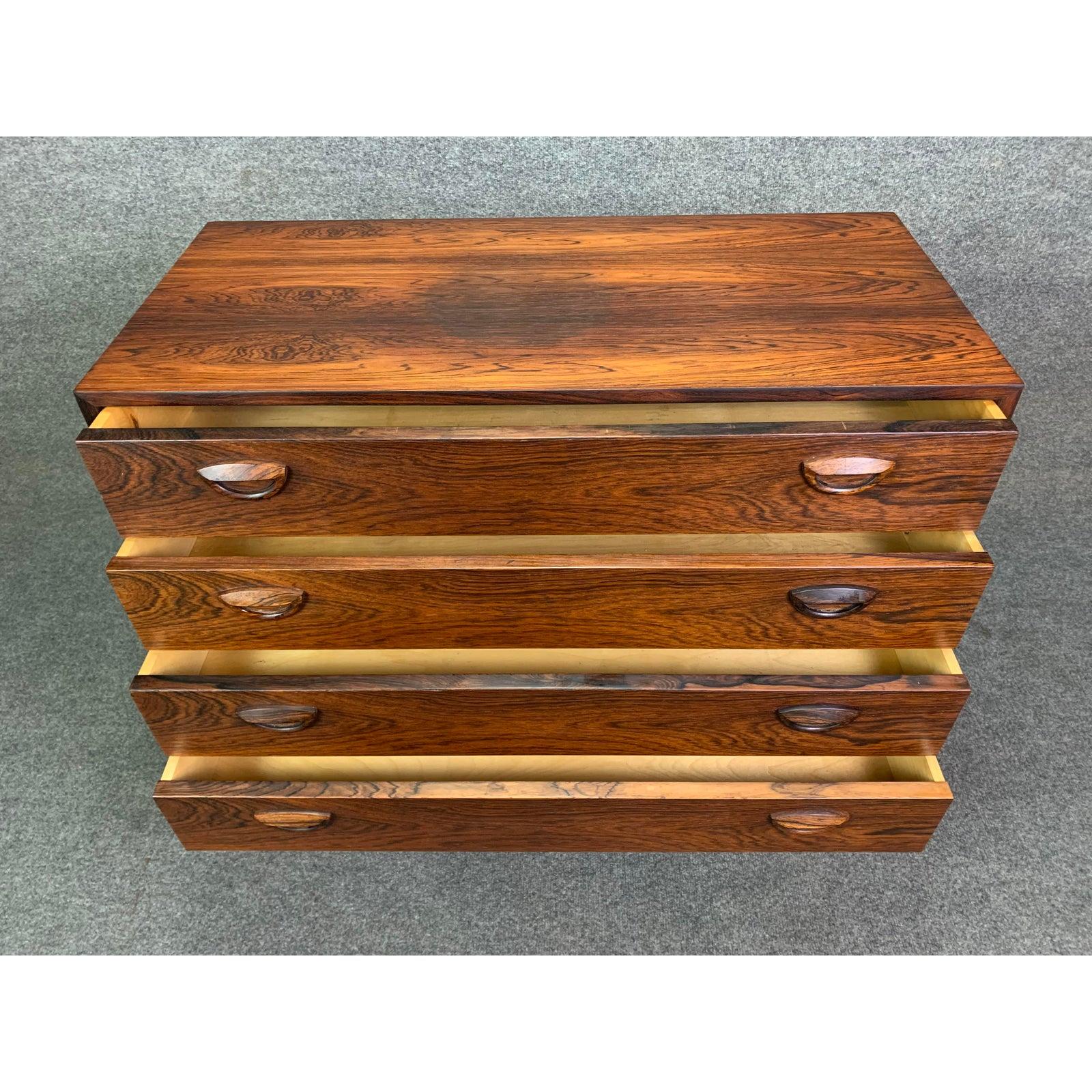 Here is a sought after Scandinavian Modern low boy dresser designed by Kai Kristiansen and manufactured by Feldballes Mobelfabrik in Denmark in the 1960s.
This exquisite chest of drawers, recently refinished, features a vibrant rosewood grain, a