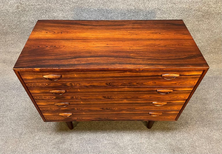 Here is a beautiful Scandinavian modern chest of drawers in Brazilian rosewood designed by Kai Kristiansen and manufactured by Feldballes Mobelfabrik in Denmark in the 1960's.
This exquisite case piece, recently imported from Europe to California