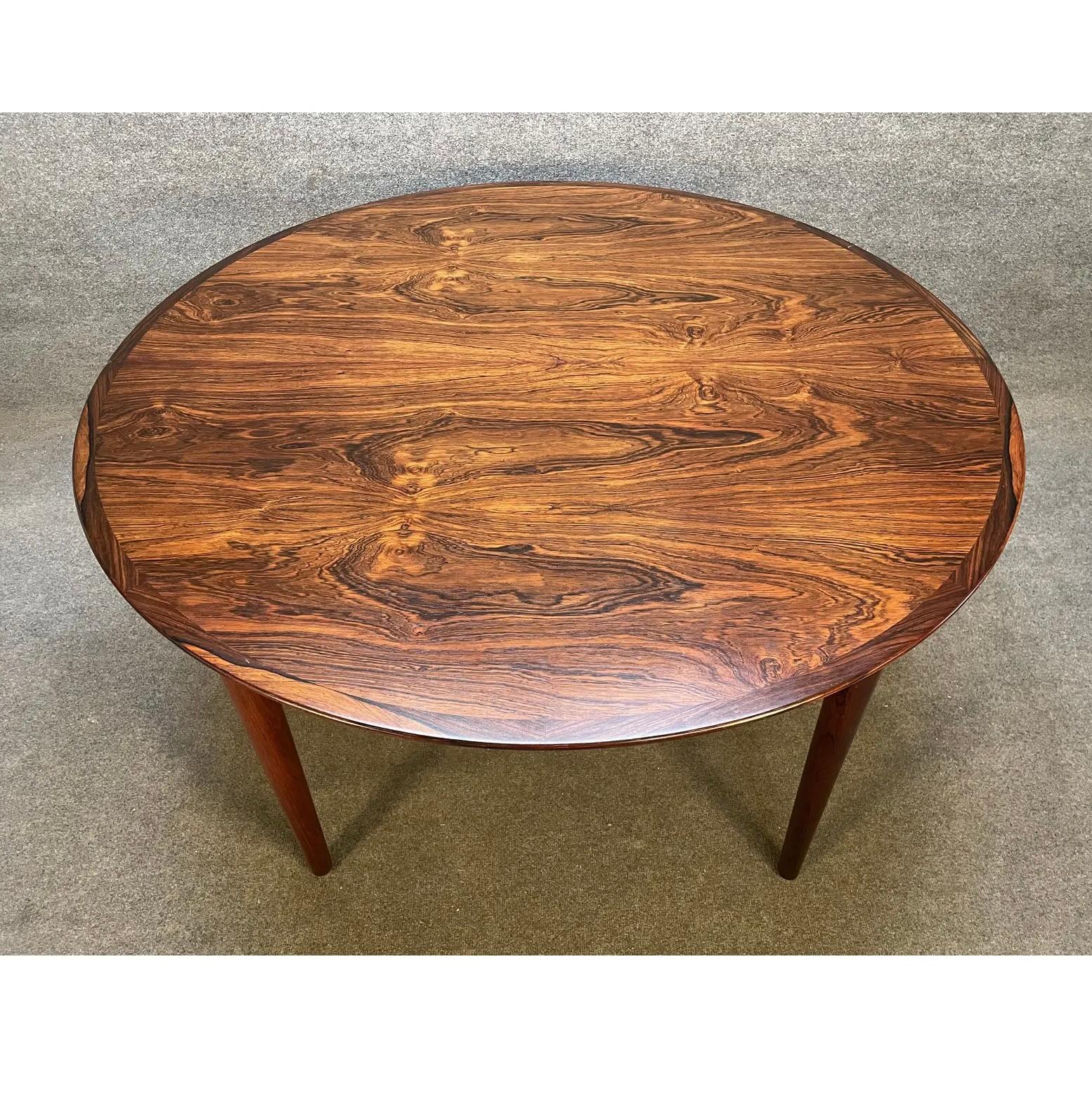 Here is a beautiful 1960's Scandinavian Modern dining table in Brazilian rosewood attributed to famed designer Johannes Andersen.
This table, recently imported from Denmark to California before its refinishing, features. a circular shape, a top