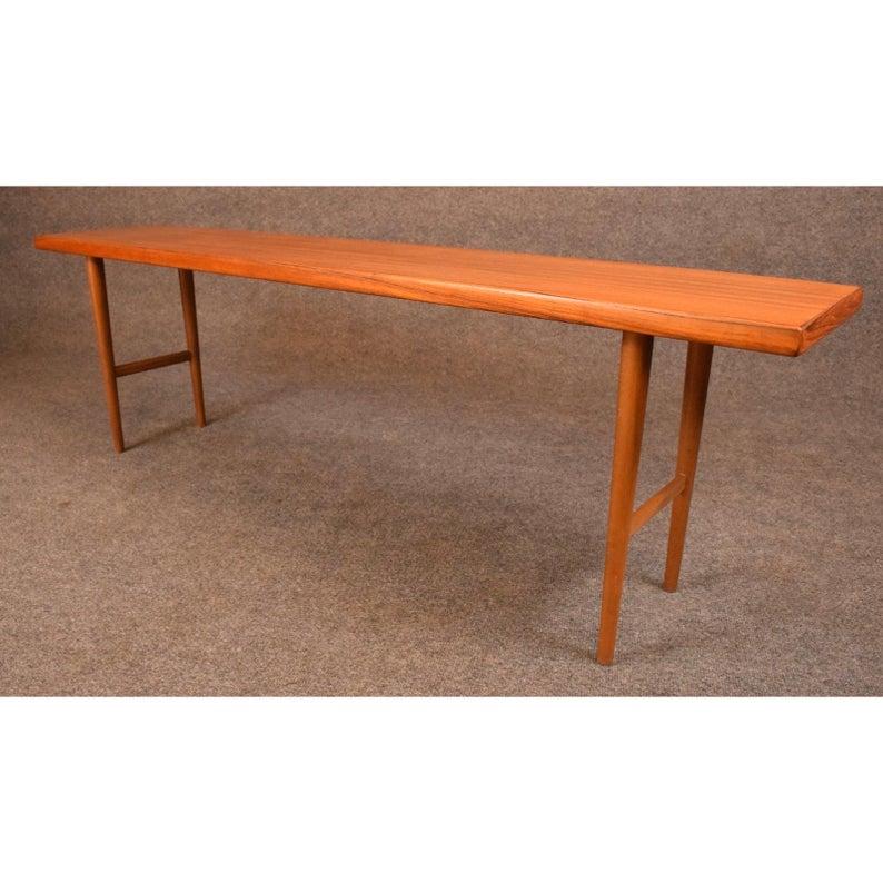 Here is a stylish 1960s teak bench designed by Kurt Østervig and produced by Jason Mobler in Denmark. This Minimalist bench was recently imported from Copenhagen to California before its restoration.
Excellent condition.
Dimensions:
Width 58.5