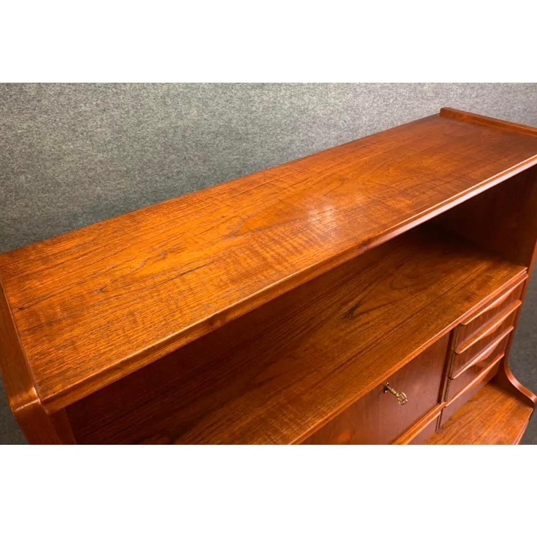 Here is a beautiful Scandinavian modern teak secretary desk attributed to Erling Torvits, Denmark, 1960's.
This case piece, recently imported from Copenhagen to California before its restoration.
features on its upper side a bookshelf, a cubby with