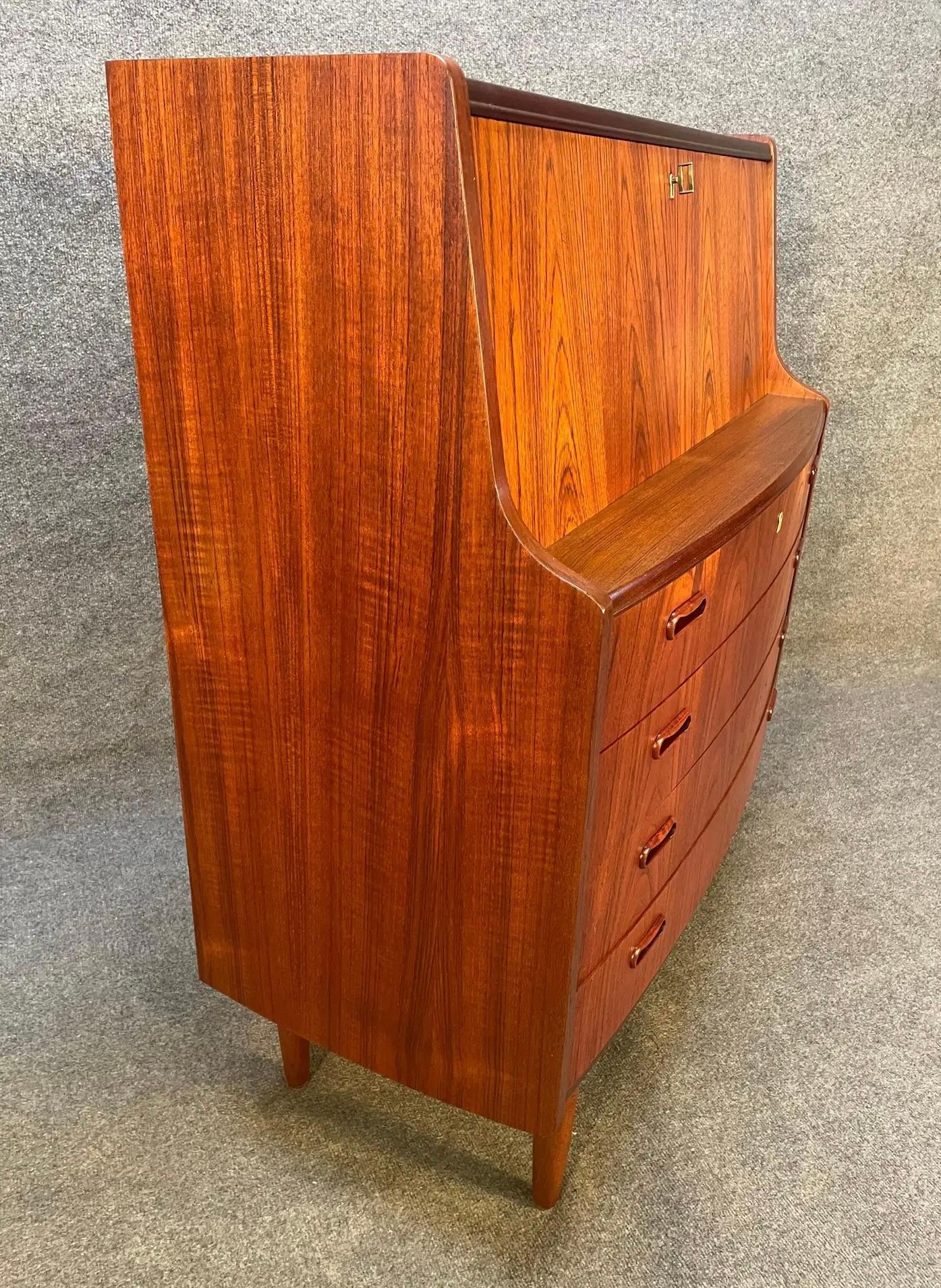 Here is a beautiful scandinavian modern secretary desk in teak wood manufactured by Poul Jessen Mobelfabrik in Denmark in the 1960s. This lovely versatile piece, recently imported from Europe to California before its refinishing, features a vibrant