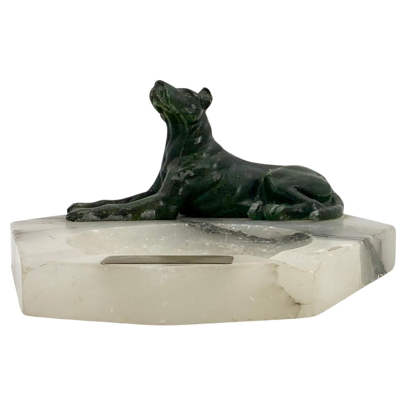 Vintage Danish midcentury white agate dog ashtray.
The marble ashtray has a green painted metal dog and a signed brass plaques dated 1948.
 
