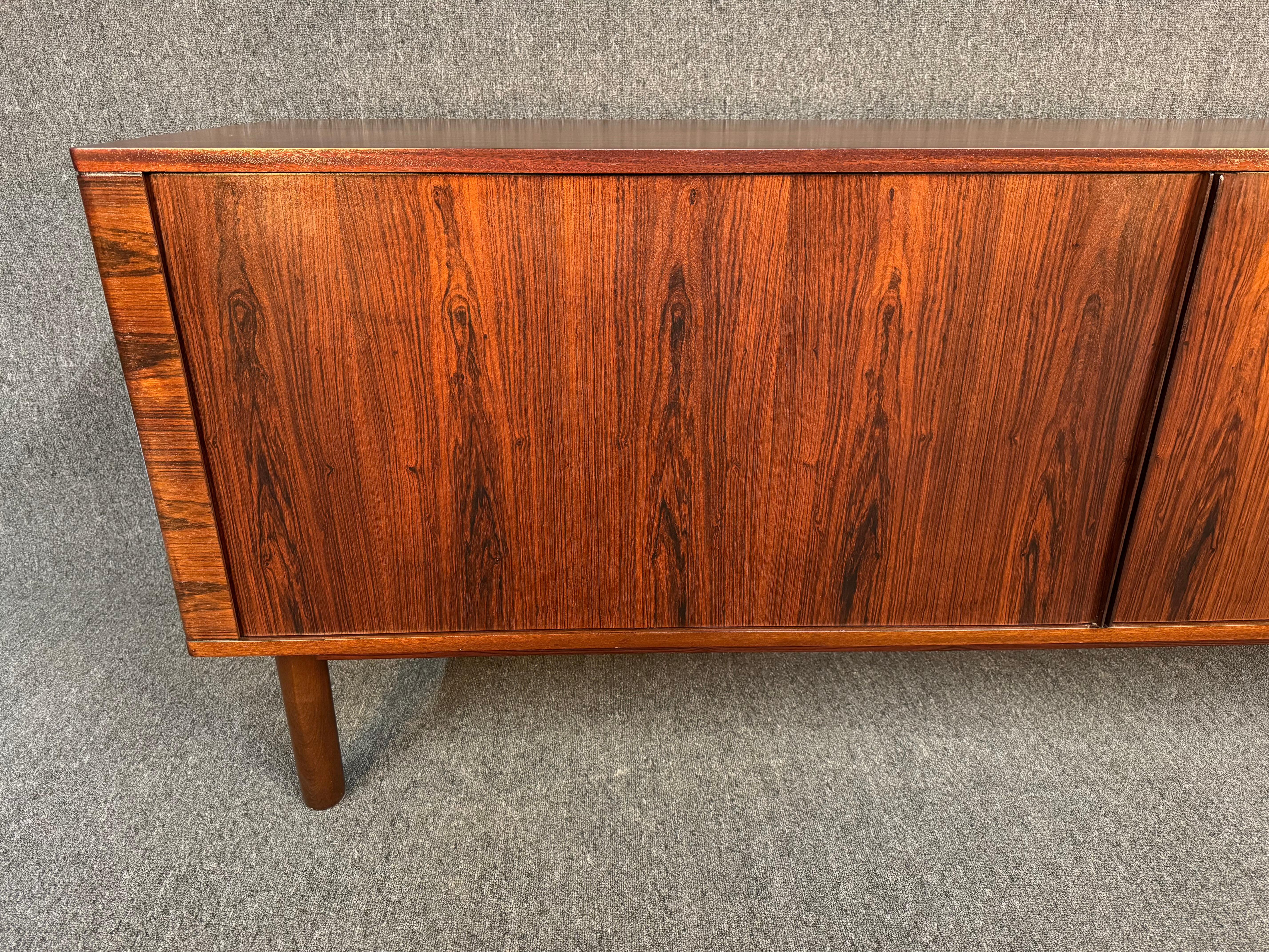 Here is a rare and beautiful Scandinavian modern sideboard in rosewood manufactured by Hornslet Mobelkfabrik in Denmark in the 1960's.
This lovely piece, recently imported from Europe to California before its refinishing, features a vibrant wood
