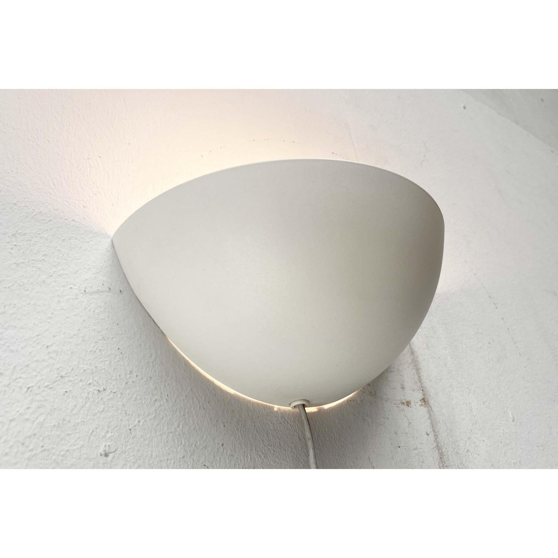 Wall light from the Danish manufacturer Lyskilde.

A minimalist design. The metal lamp body features the simple shape of a quarter sphere. The lamp features a cable outlet, allowing it to be connected via a plug and cord switch, or directly.
The