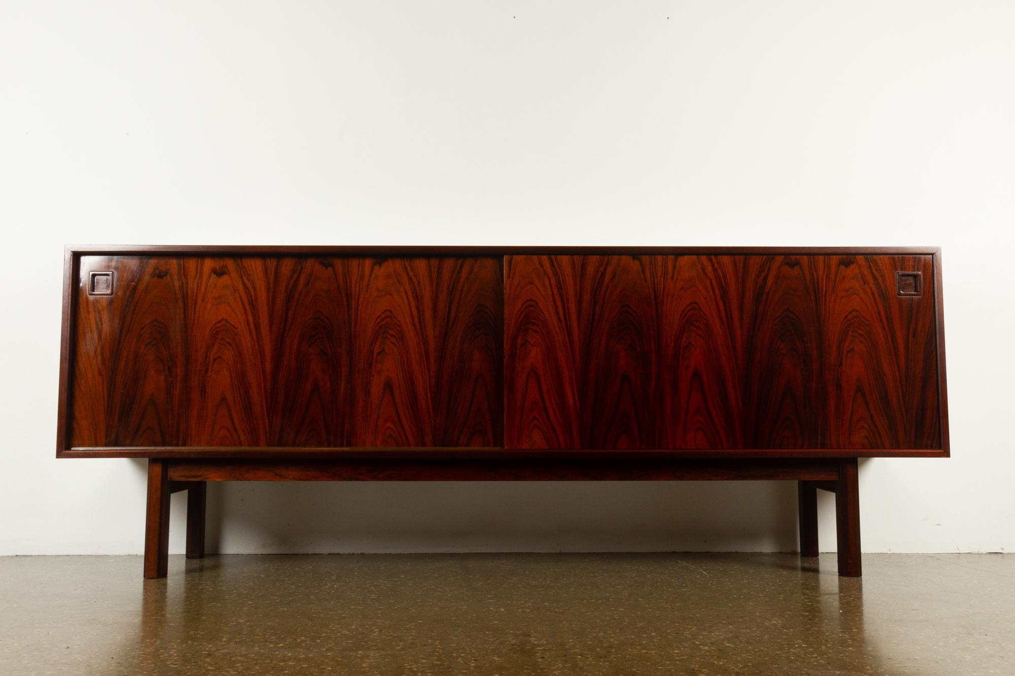 Vintage Danish model 21 sideboard from Omann Jun, 1960s. Designed in 1965.
Amazingly beautiful rosewood low board with stunning wood grain.
Two long sliding doors with square grips in solid rosewood. Behind the doors are two compartments with