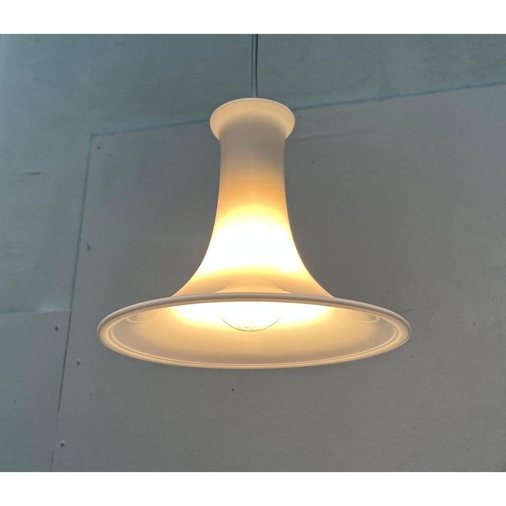 Elegante lampada a sospensione in vetro del produttore danese Holmegaard su disegno di Michael Bang degli anni Settanta.

Una bozza in linguaggio formale tradizionale. Questa lampada a sospensione convince per le sue curve eleganti. Il vetro opalino