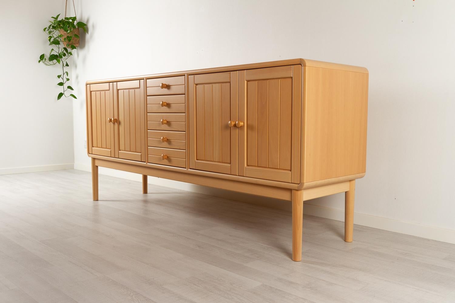 Vintage Scandinavian Modern beech sideboard by Falsig Møbelfabrik, 1980s
Long lowboard in the light nordic design. Loads of storage space in the two cabinets and five drawers. The body has rounded corners in light blond solid beech, and the double
