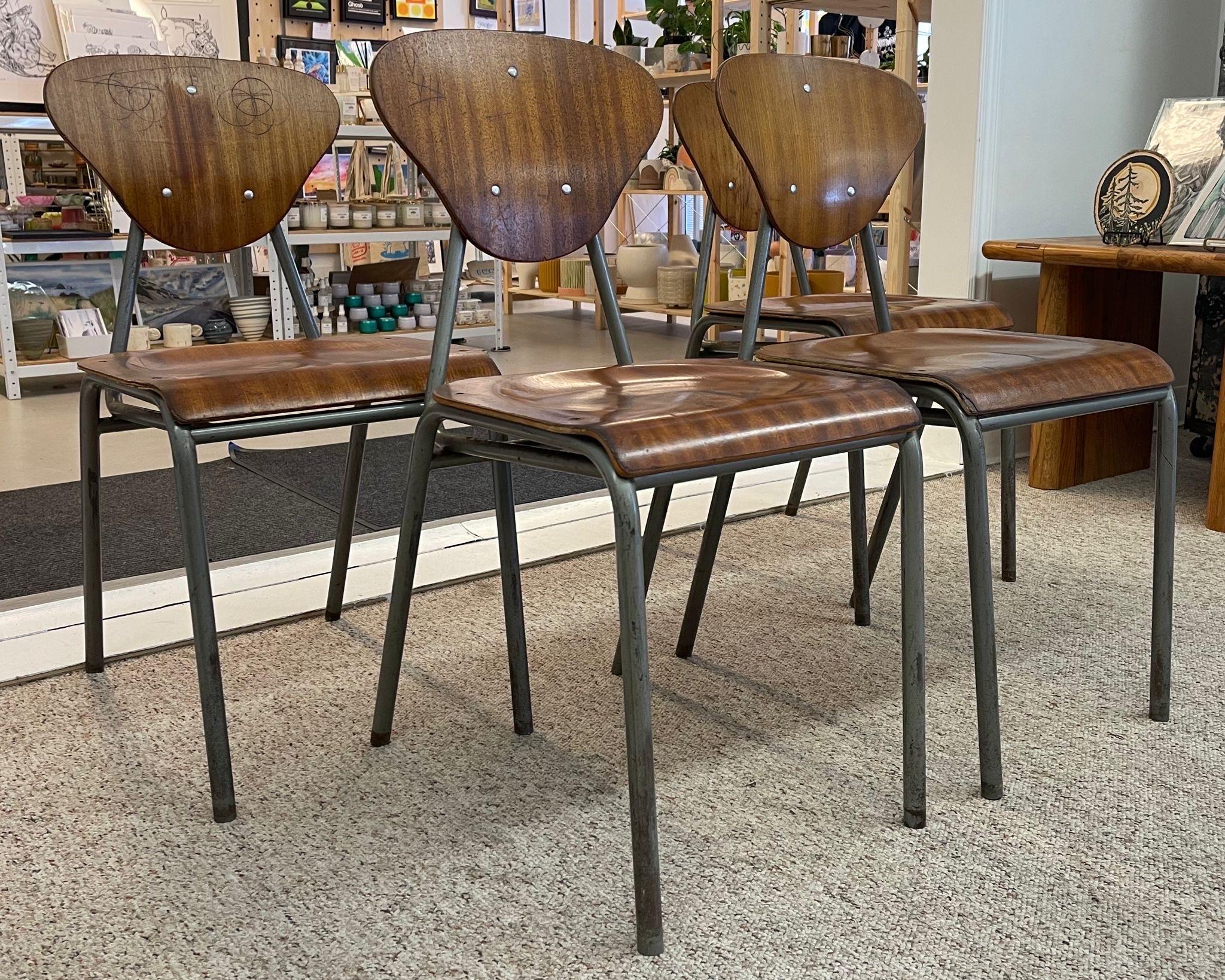 Set of four metal frame chairs with curved wood seats and back. No Makers mark. Vintage condition consistent with age as Pictured.

Dimensions. 16 W ; 16 D ; 32 H