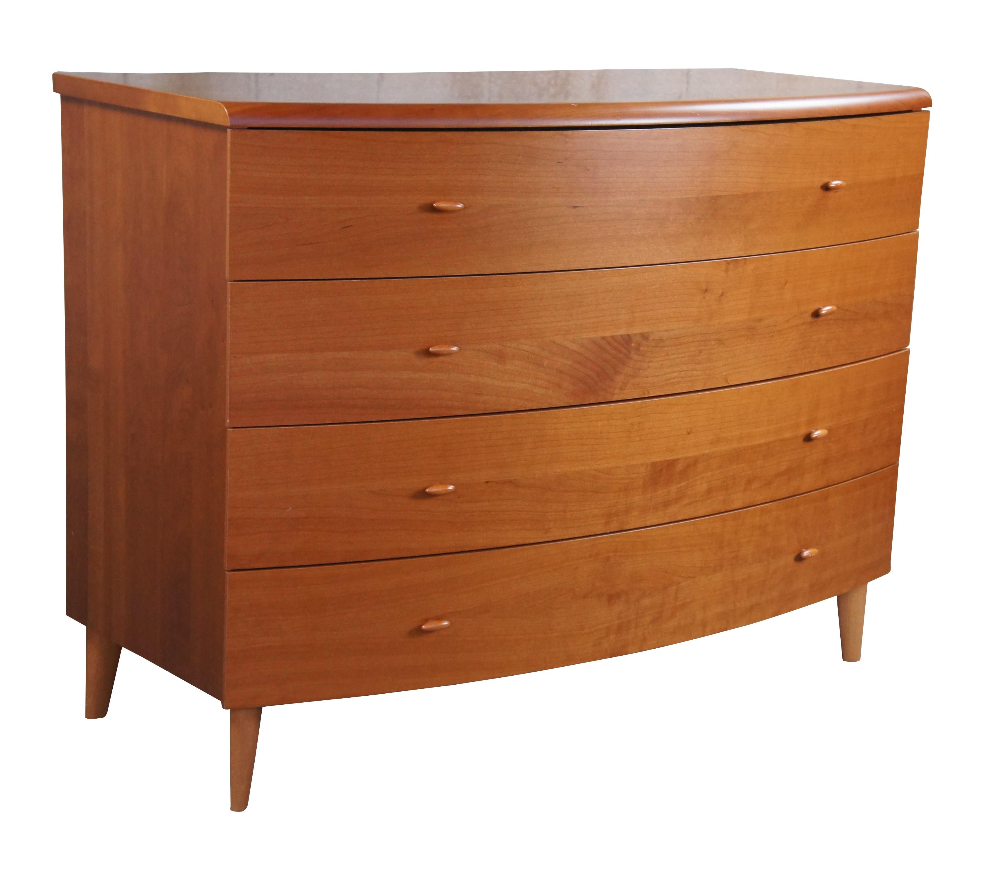 Vintage chest of drawers / dresser / console.  Made of cherry featuring mid century / Danish modern styling with a slight demilune or bowfront form, four drawer and tapered legs.

Dimensions:
45.5