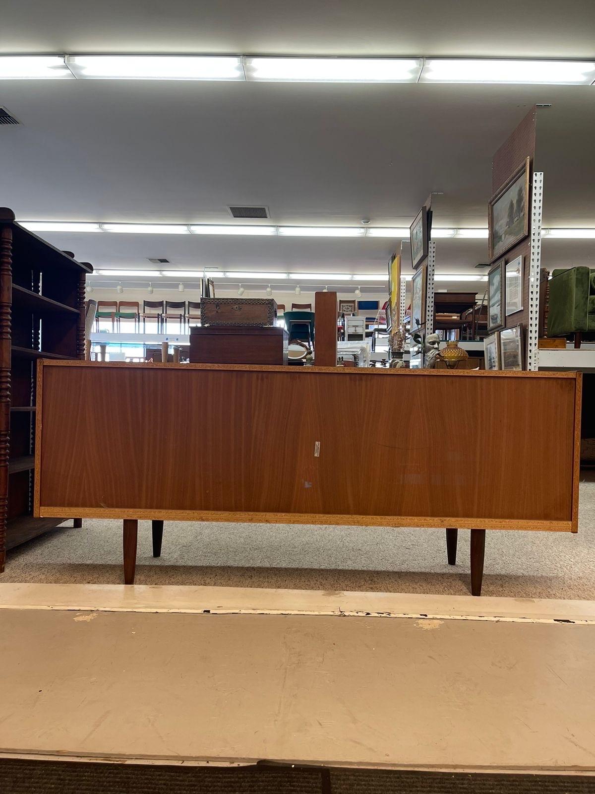 This Credenza Features Adjustable Shelves and Two FeltedDrawers with Dovetail Detailing. Makers Mark on the Back Stating “ JYDSK MOBELINDUSTRI SKANDERBORG “ . Made in Denmark as Pictured.

Dimensions. 71 W ; 17 1/2 D ; 30 H